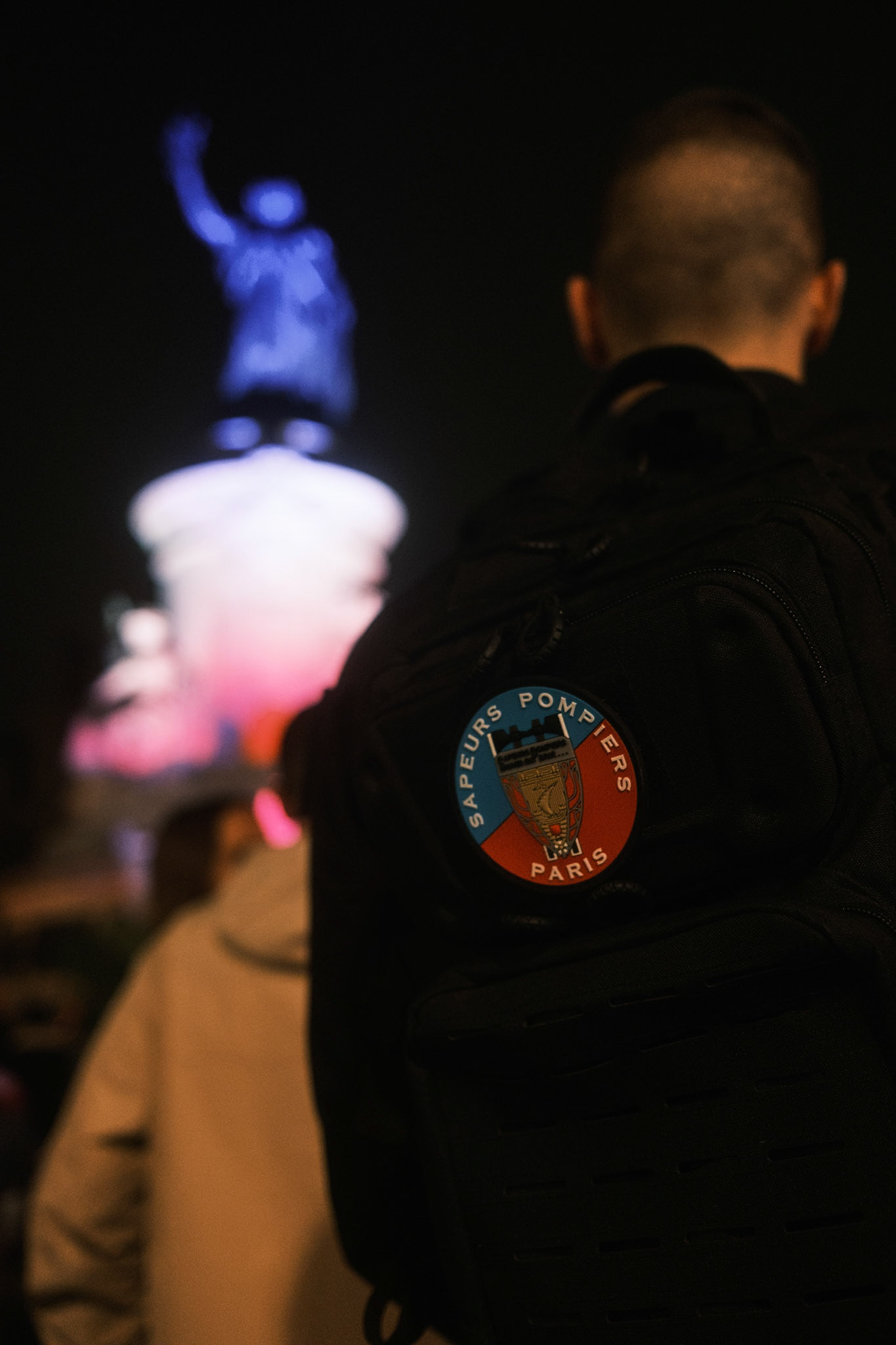 Off duty fire service officer in front of the statue of Place de la Republique during the commemorative event held by the city in honor of the victims for the 10-year-anniversary of the terrrorist attacks in Paris, on November 13th 2015. Paris, France, November 13th 2025, by Maria Kalafatsi.