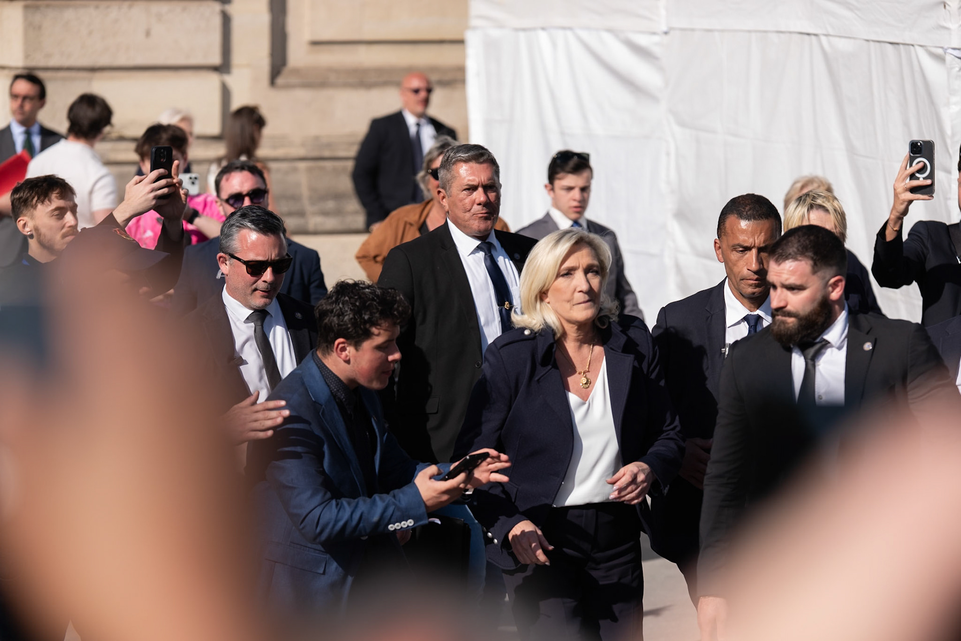 Marine Le Pen approaches the photoreporters, right after her speech in the National Rally demonstration, organised behind the Army Museum (Les Invalides), in Paris, France, April 6th 2025. Photoreporters were shouting loudly her name, after her speech, and she came back to greet them shortly. Demonstration was organised to protest the sentencing of Marine Le Pen. Paris, April 6th, Maria KALAFATSI