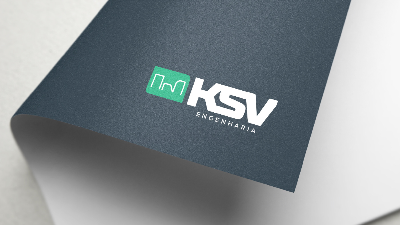 Design de marca da KSV engenharia, impressa na cor branca em uma folha em cinza escuro.