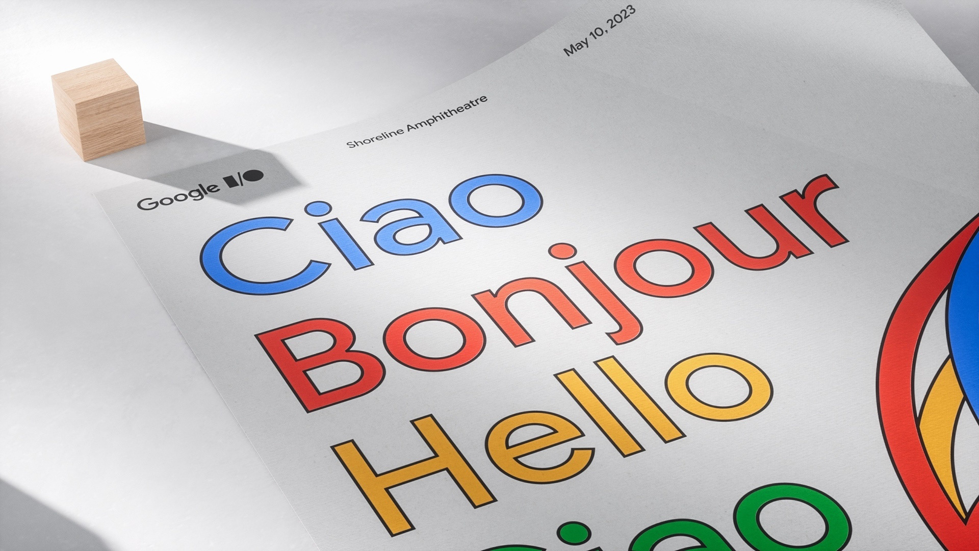 A close-up of some of the details on an event branded poster featuring colourful multilingual greetings.