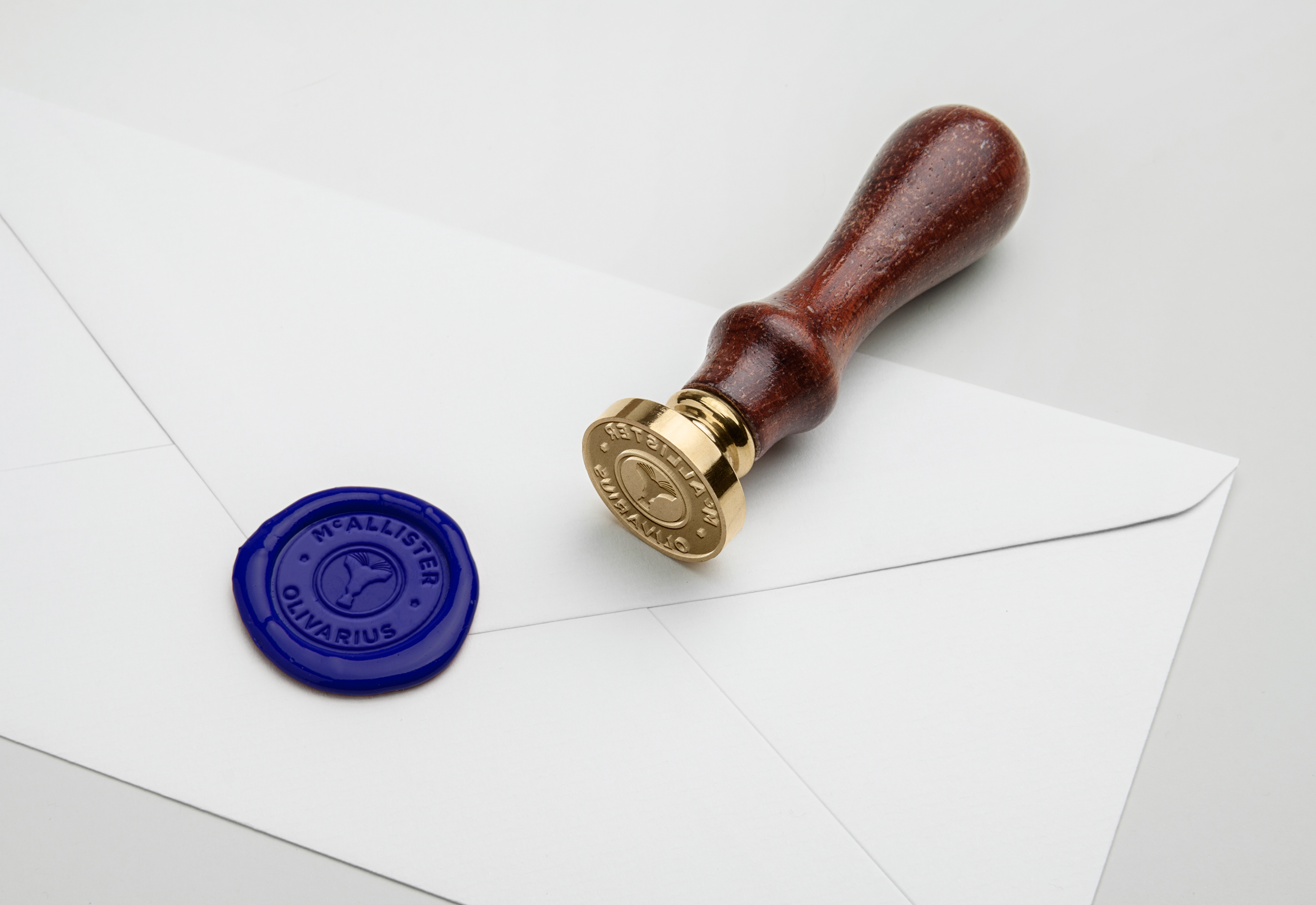 A blue wax seal with the McAllister Olivarius bespoke logo.