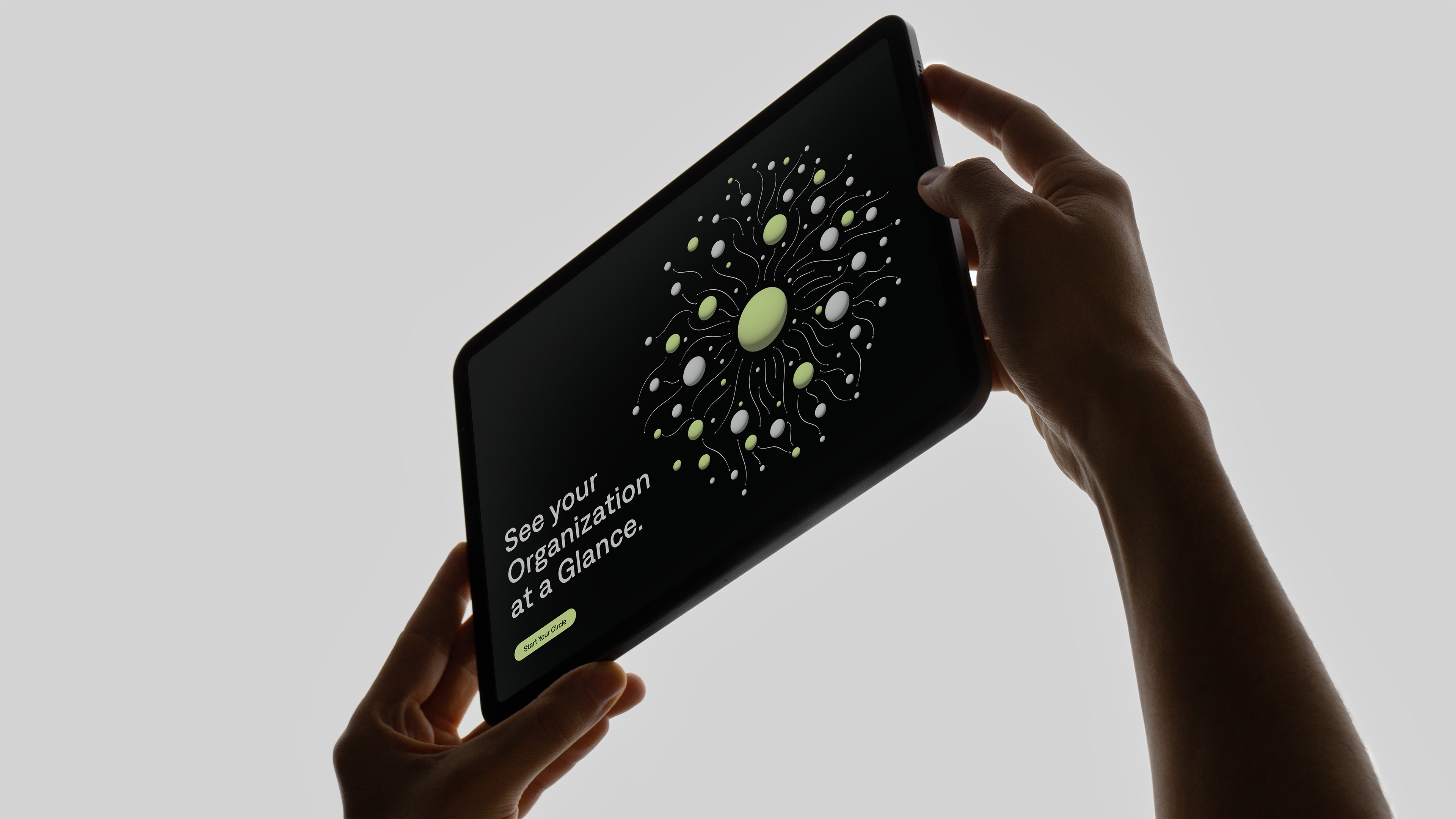A close-up image of a tablet featuring the Coordinape website with a symbiotic connected dots pattern and the title, 'See your organisation at a glance.'
