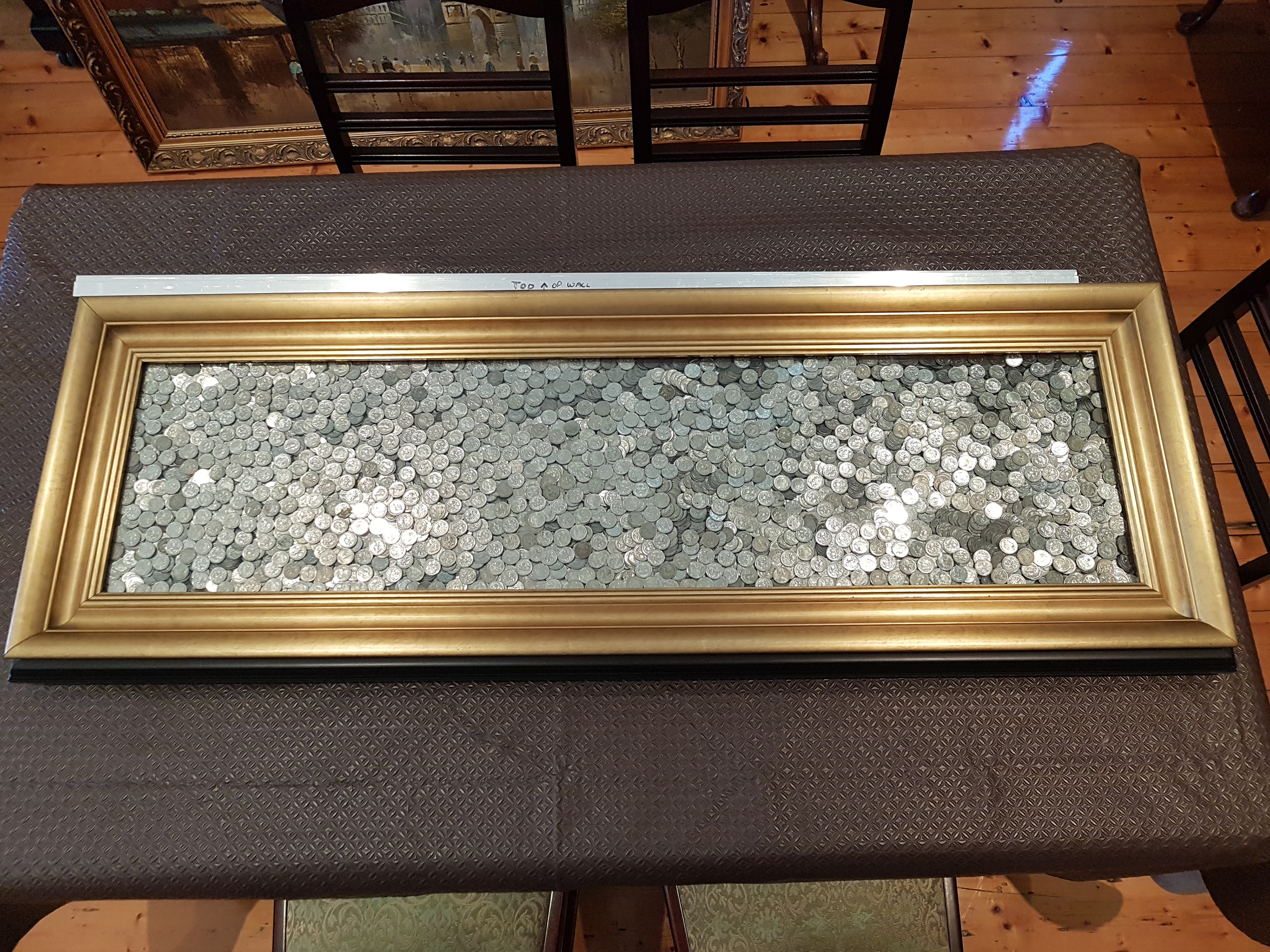 Australian 5 cent pieces in a giant gold-framed picture frame totalling $700.