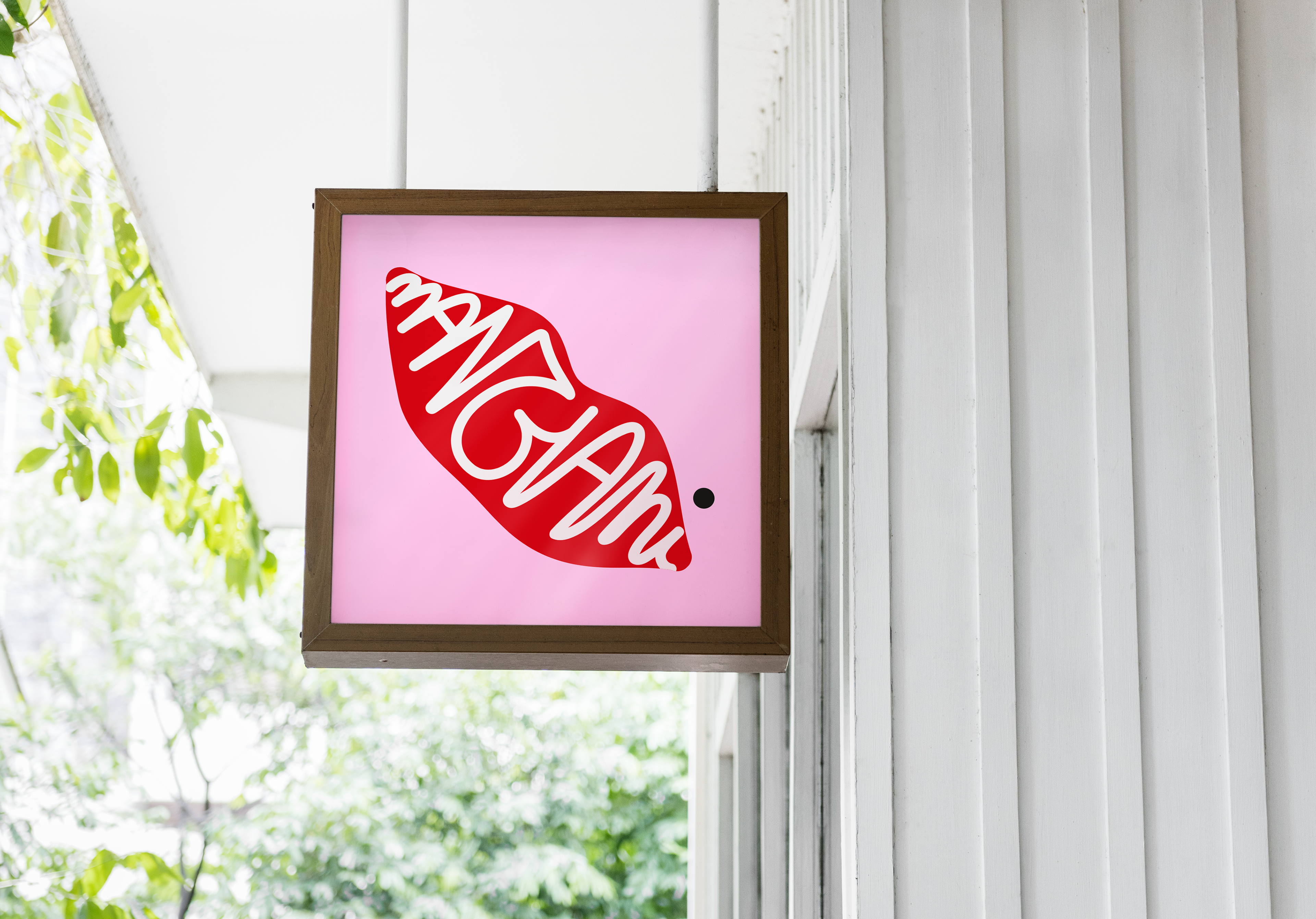 A pink lightbox outside a shopfront with the Mangiami illustrated logo adorning it.