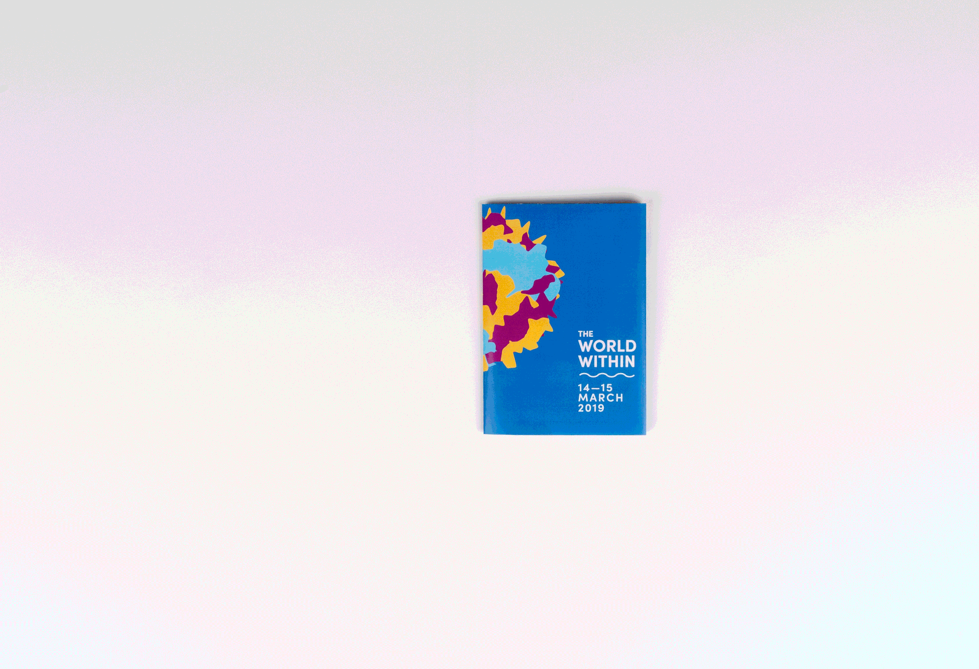 A gif featuring the usage of a multi-fold brochure of The World Within event.