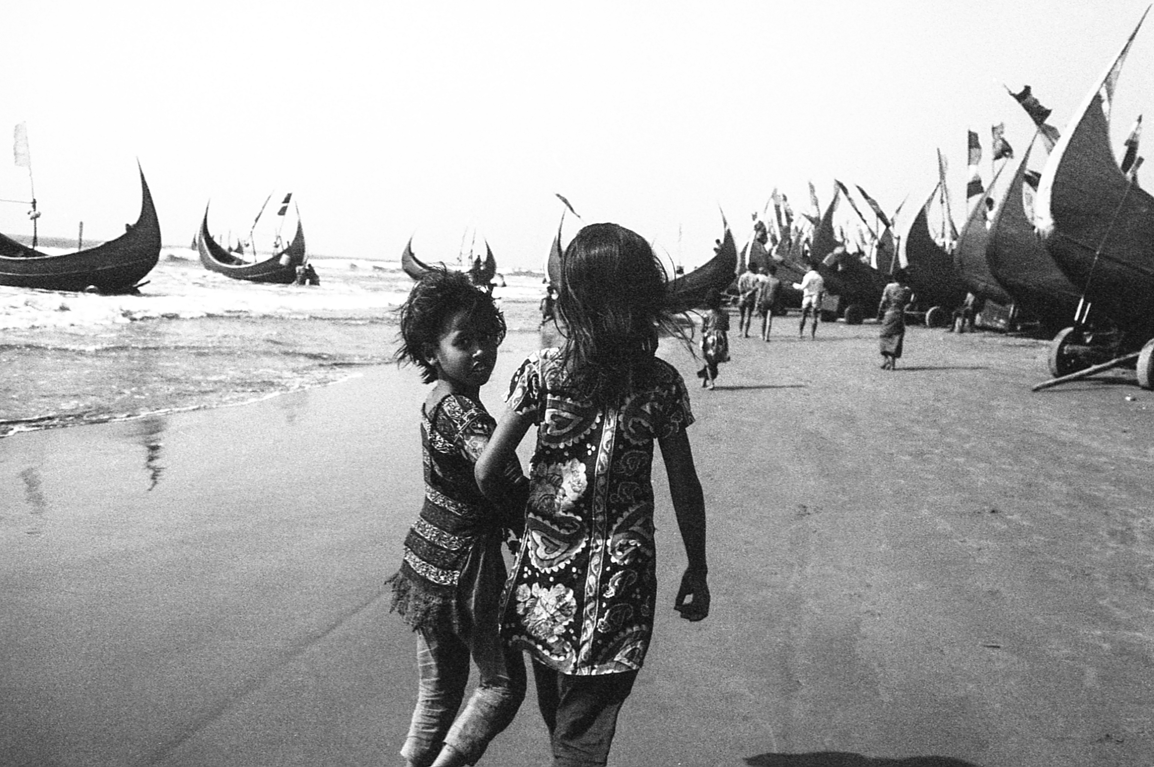 Shamlapur, Bangladesh. Two girls walk along the beach.