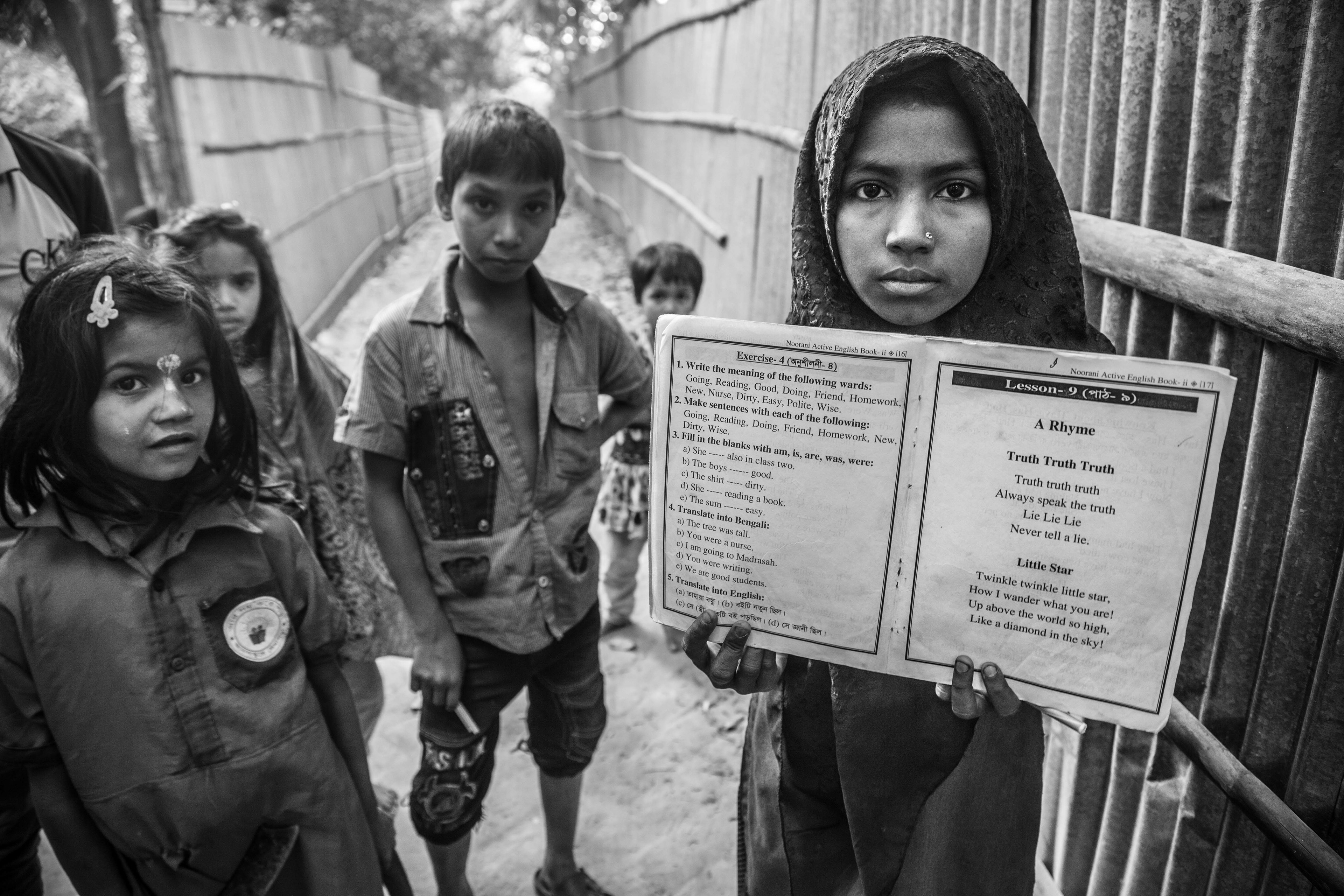 "Lie, Lie, Lie." Leda Camp, Teknaf, Bangladesh. Jan 2016. In camps for unregistered refugees, there is no formal education offered. So, families that can afford it, purchase forged Bangladeshi documents for their children in order for them to participate in public primary and high schools. Others receive lessons under the Noorani curriculum, which combines religious and secular studies. Of the 8,000 children that reside in Leda Camp, only about 1,500 attend some kind of school.