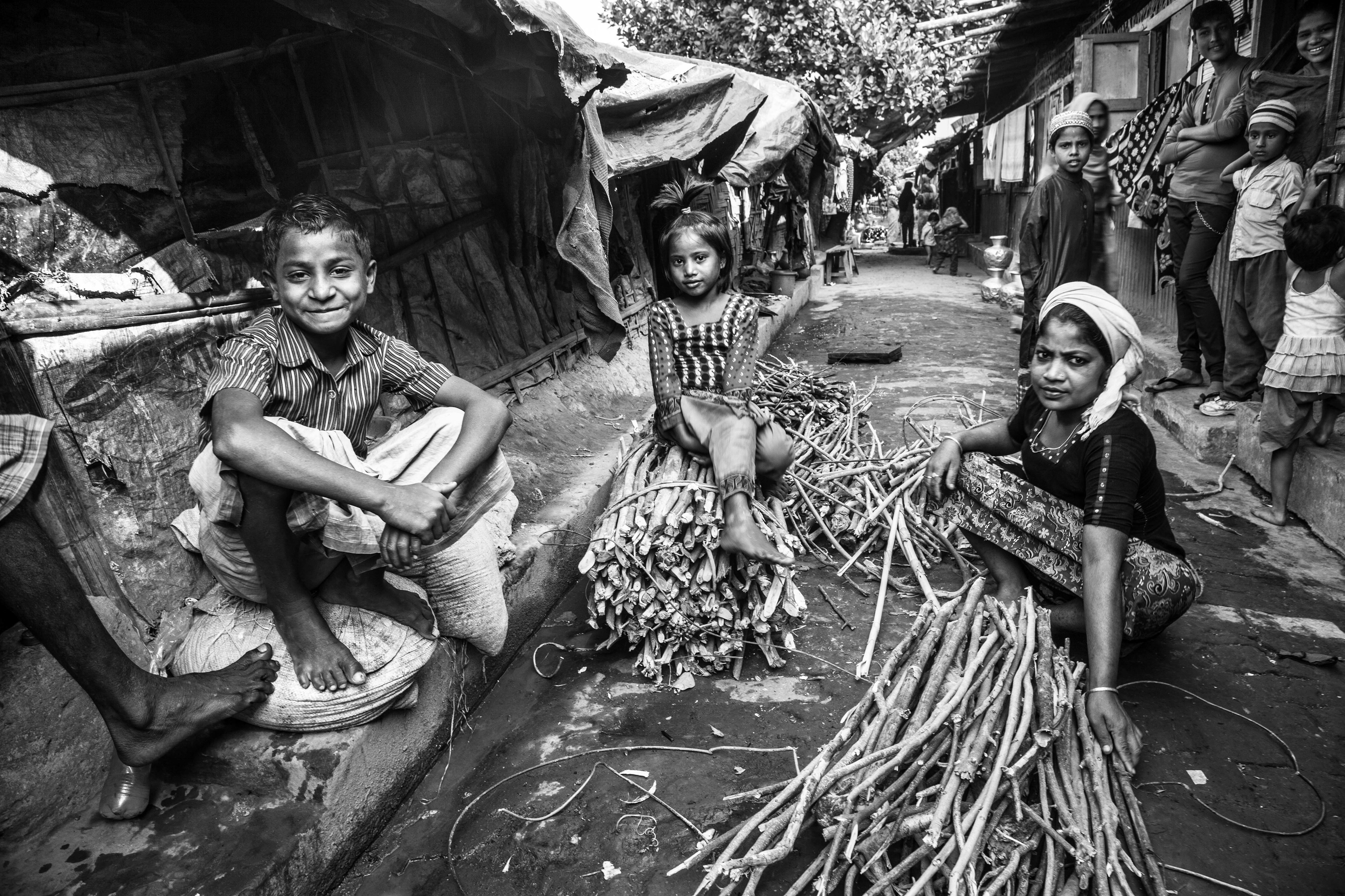 "Bundling Firewood." Leda Camp, Teknaf, Bangladesh. Jan 2016. To support their families, many Rohingya rely on collecting and selling firewood. In the forests and on the roads outside of the camp, they are more exposed and are often victims of violent crimes by locals and police, especially the women.