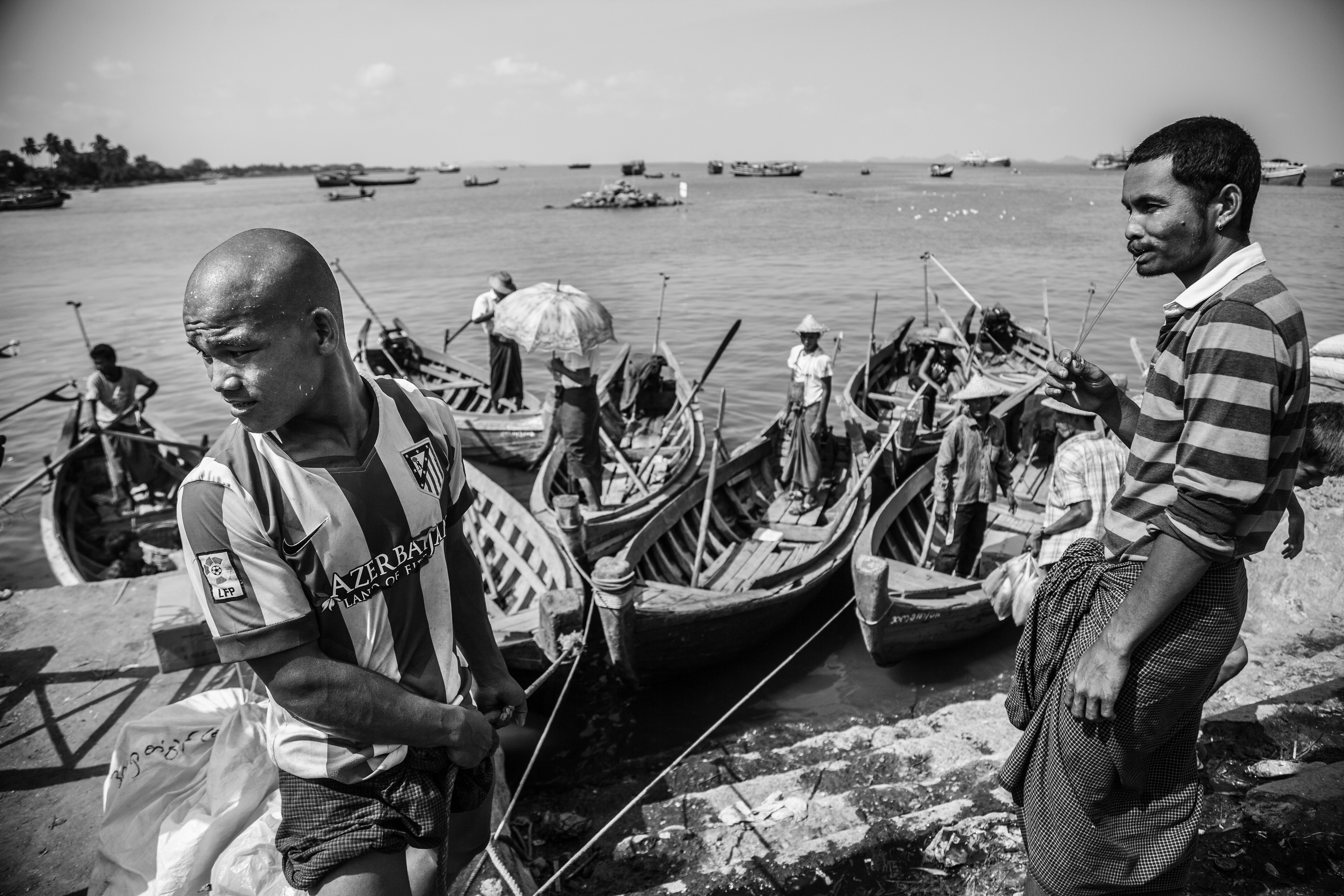 "Pier at Sittwe Market." Sittwe, Myanmar. May 2016. Rohingya and Rakhine Buddhists once traded freely in this large market, but after waves of violence in 2012, there are no longer Rohingya-owned stalls or boats that operate here. In fact, the only Rohingyas that remain in downtown Sittwe are cordoned off by armed police checkpoints and barbed wire in a quarter called Aung Mingalar.