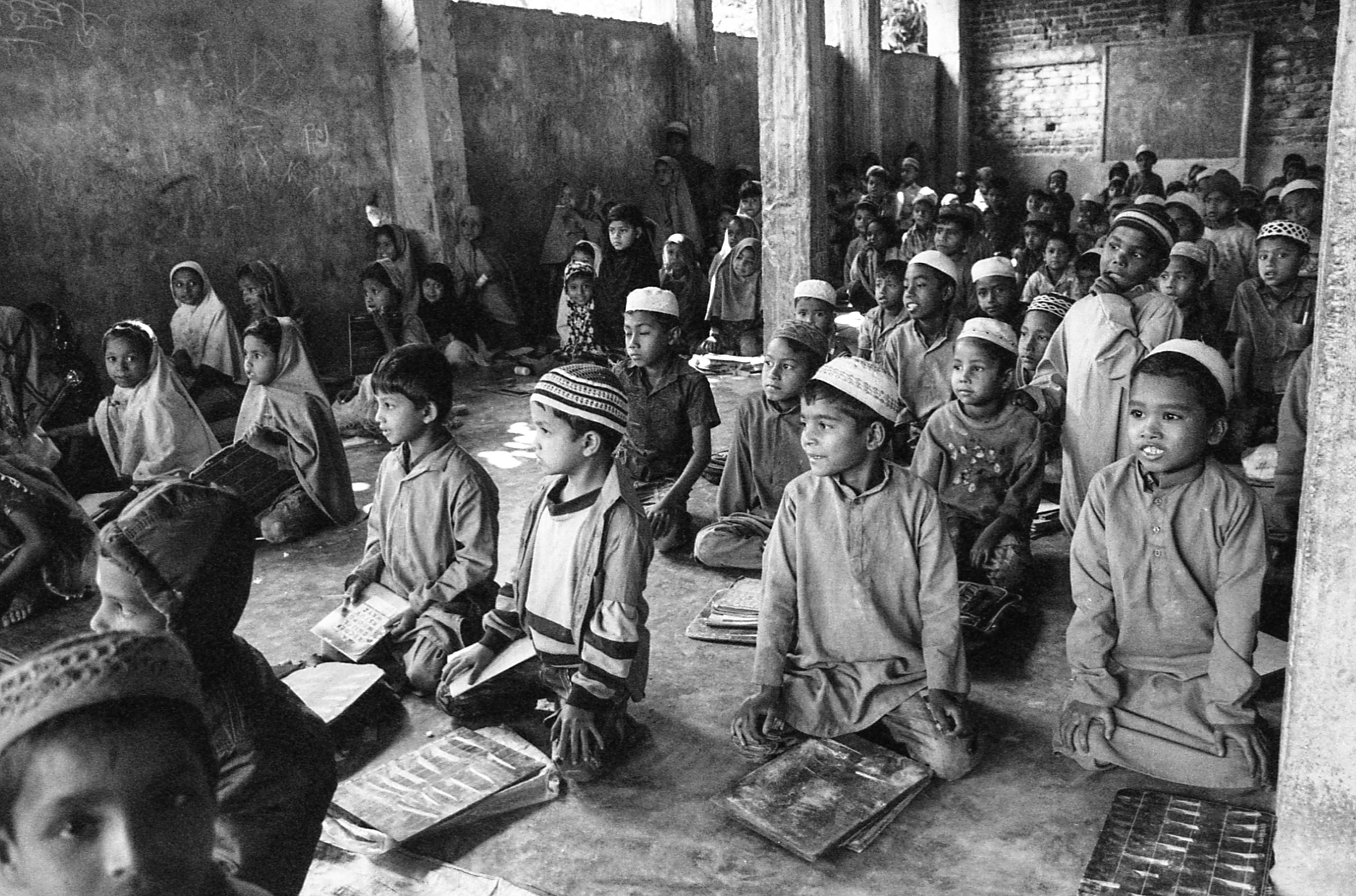 Shamlapur, Bangladesh. A group of teachers here allows Rohingya children to sit in on lessons with the local Bengali kids. They pay about $1-2 USD per month for lessons 6 days a week.