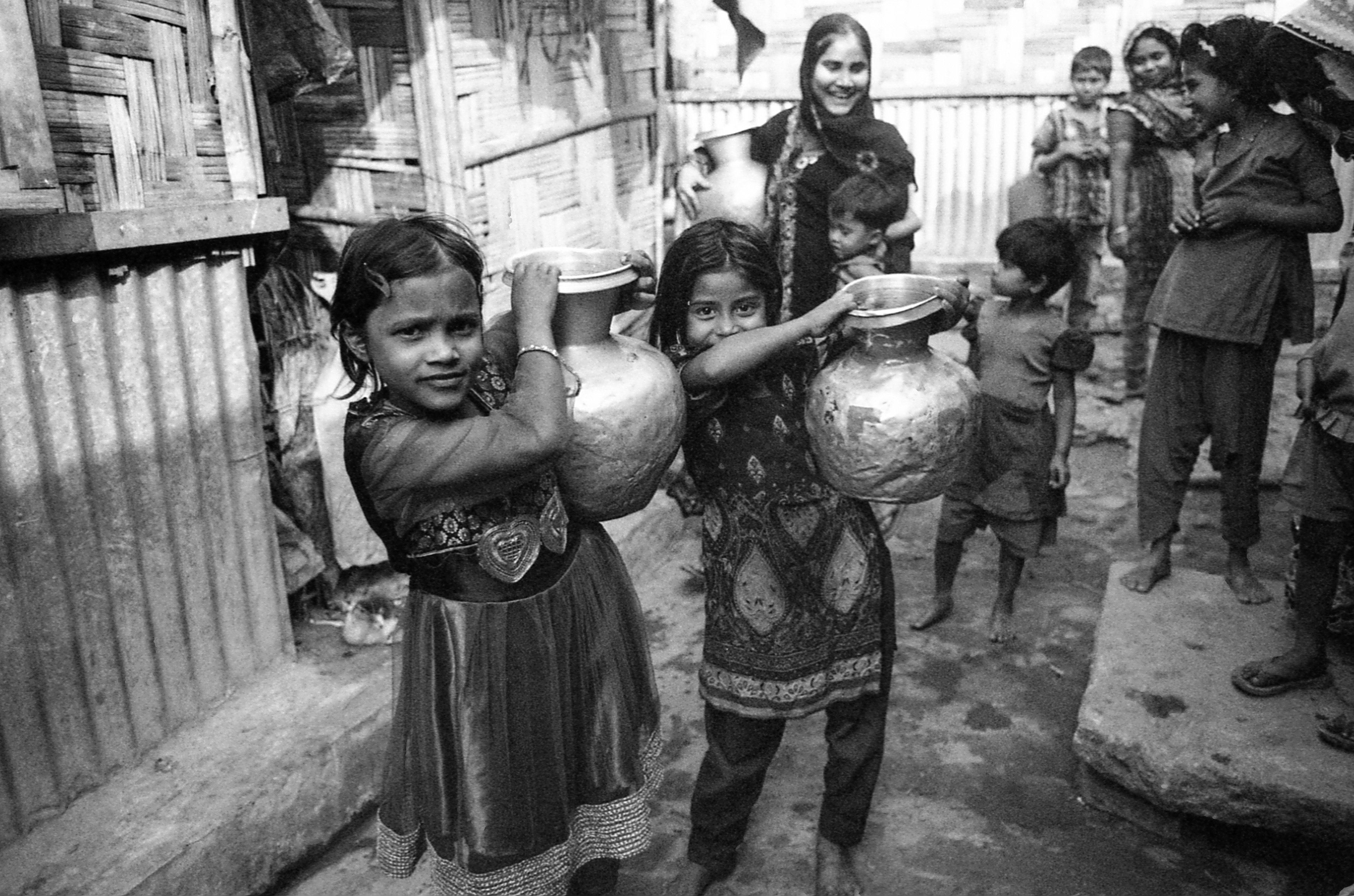 Leda Camp, Teknaf, Bangladesh. Girls coming home with jugs of water.