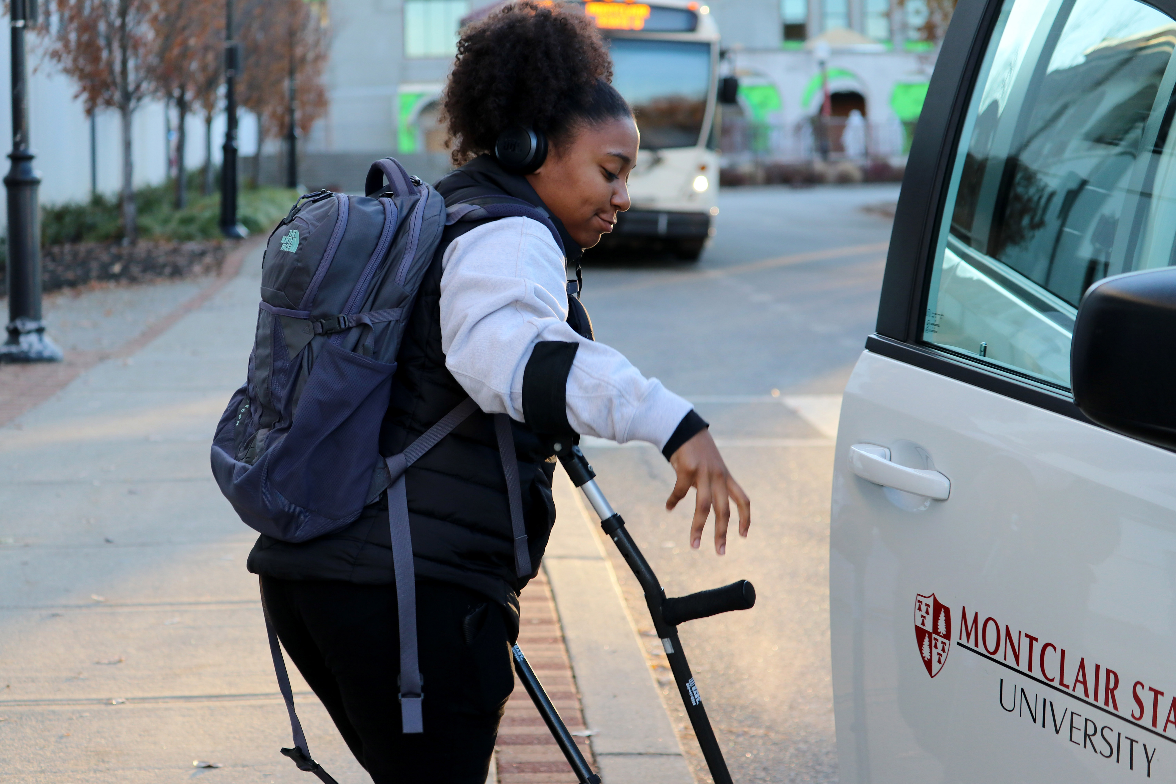 MONTCLAIR, NJ 11/21/2019 TRINITY TRIES TO OPEN THE DOOR HERSELF: Trinity Corney tries to open the door of the Montclair State University Persons with Disabilities (PWD) minivan for the third time. After this photo, she gets the door open herself. -Photo by Sunah E. Choudhry