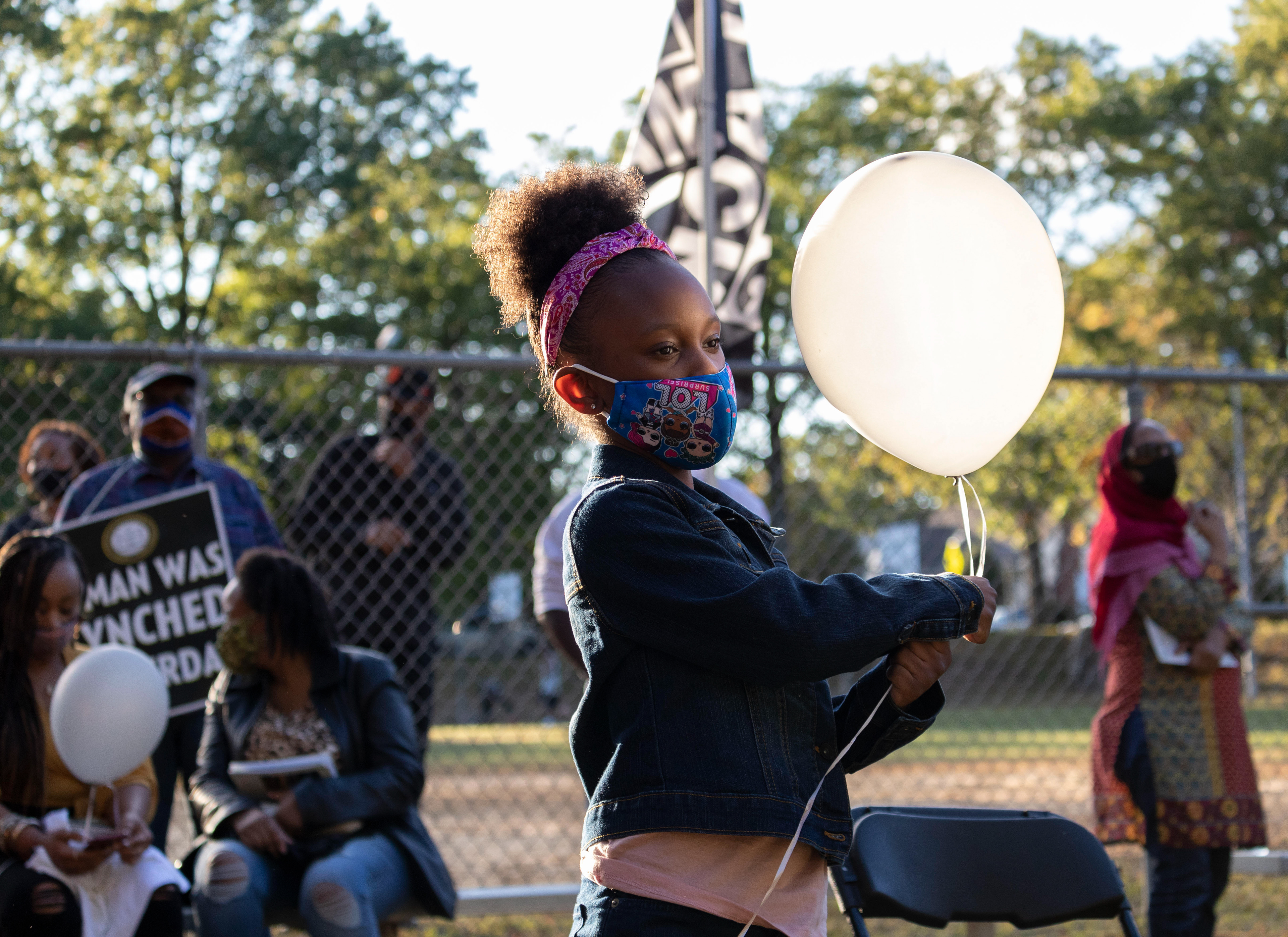 A girl holds onto her balloon in remembrance of Phillip Pannell on his 47th birthday at Bernard E. Brooks park in Teaneck on Saturday, October 3rd, 2021. (Photo/Sunah Choudhry)