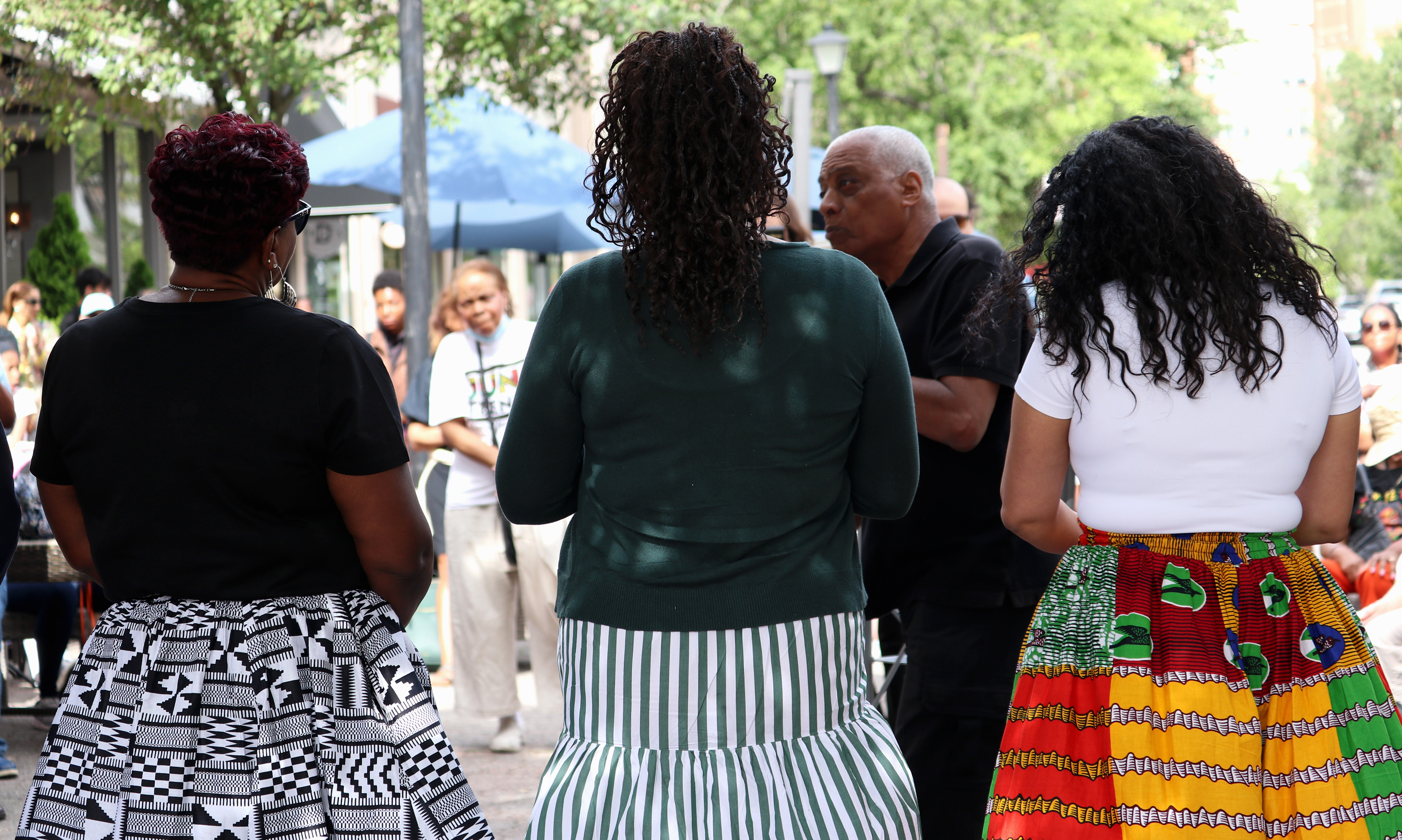 MONTCLAIR, NJ 06/19/2026 JUNETEENTH FLAG RAISING: United States Representative (NJ-10) Lamonica Mciver, 4th Ward Counsilor Aminah Toler, and United States Representative (NJ-11) Analilia Mejia stand side-by-side wearing African Ankara skirts provided by Syline Pateat. Photo by Sunah Choudhry.