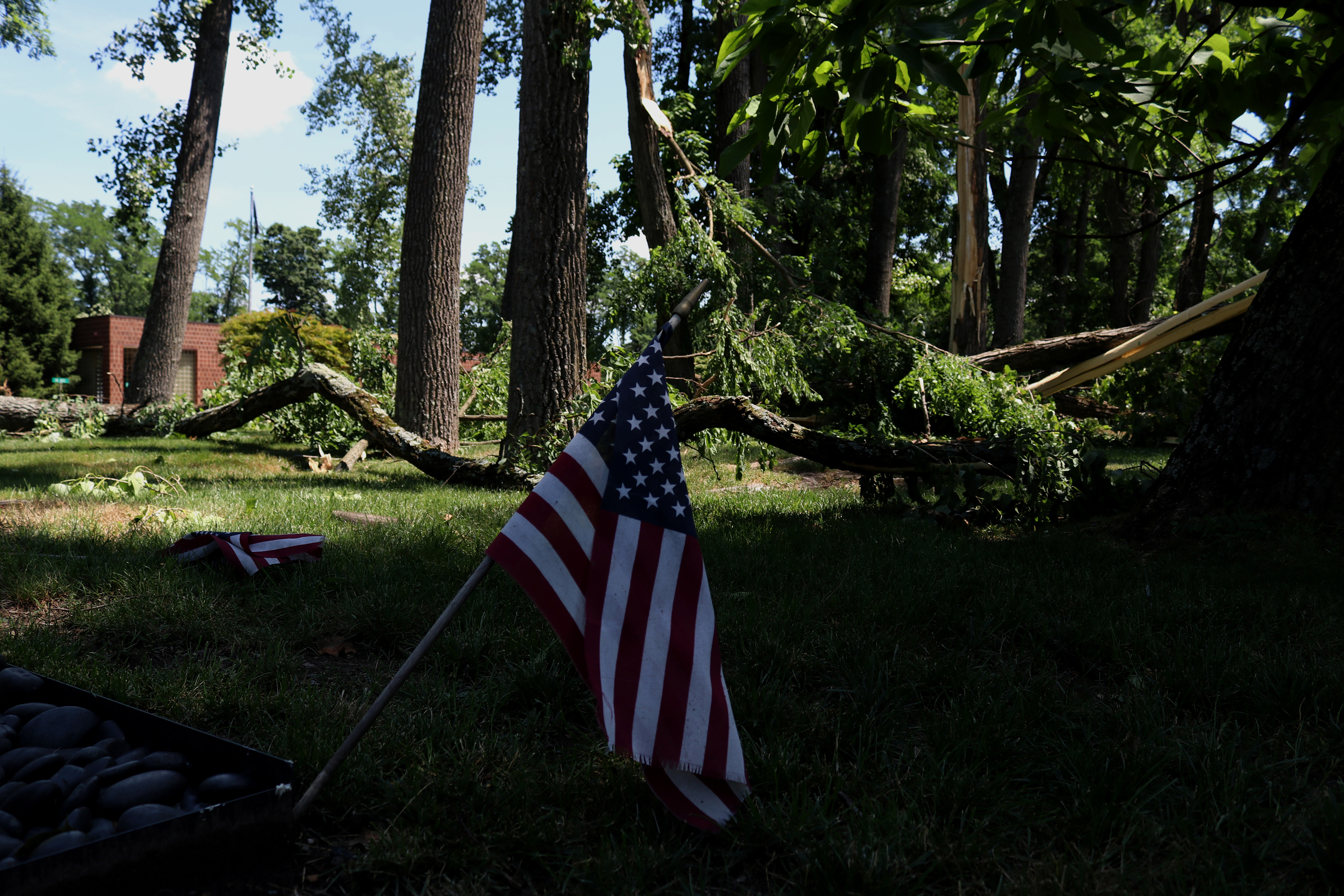 An American flag stands after powerful winds knock down multiple trees on the grounds of the Veterans of Foreign Affairs #3401 after a powerful storm in Morris Plains, New Jersey. Photo by Sunah Choudhry.