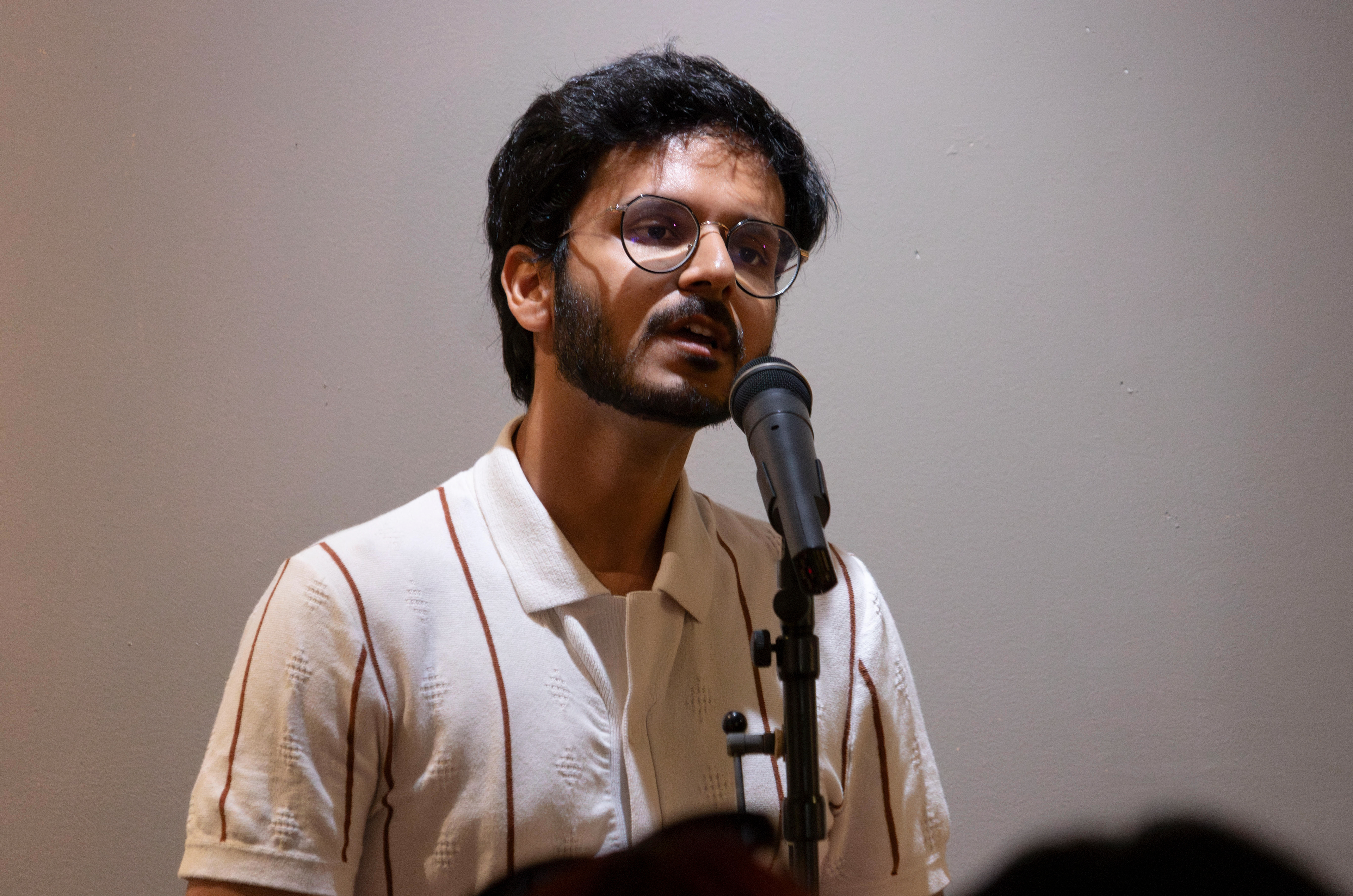 NEW BRUNSWICK, NJ 06/20/2026 CANVAS AND KAHANI: Poet Munsif Husami performs spoken word poetry to the crowd. Central Desi, a South Asian news publication, hosts its first-ever art showcase and open-mic at Alfa Art Gallery on Church Street. Photo by Sunah Choudhry.