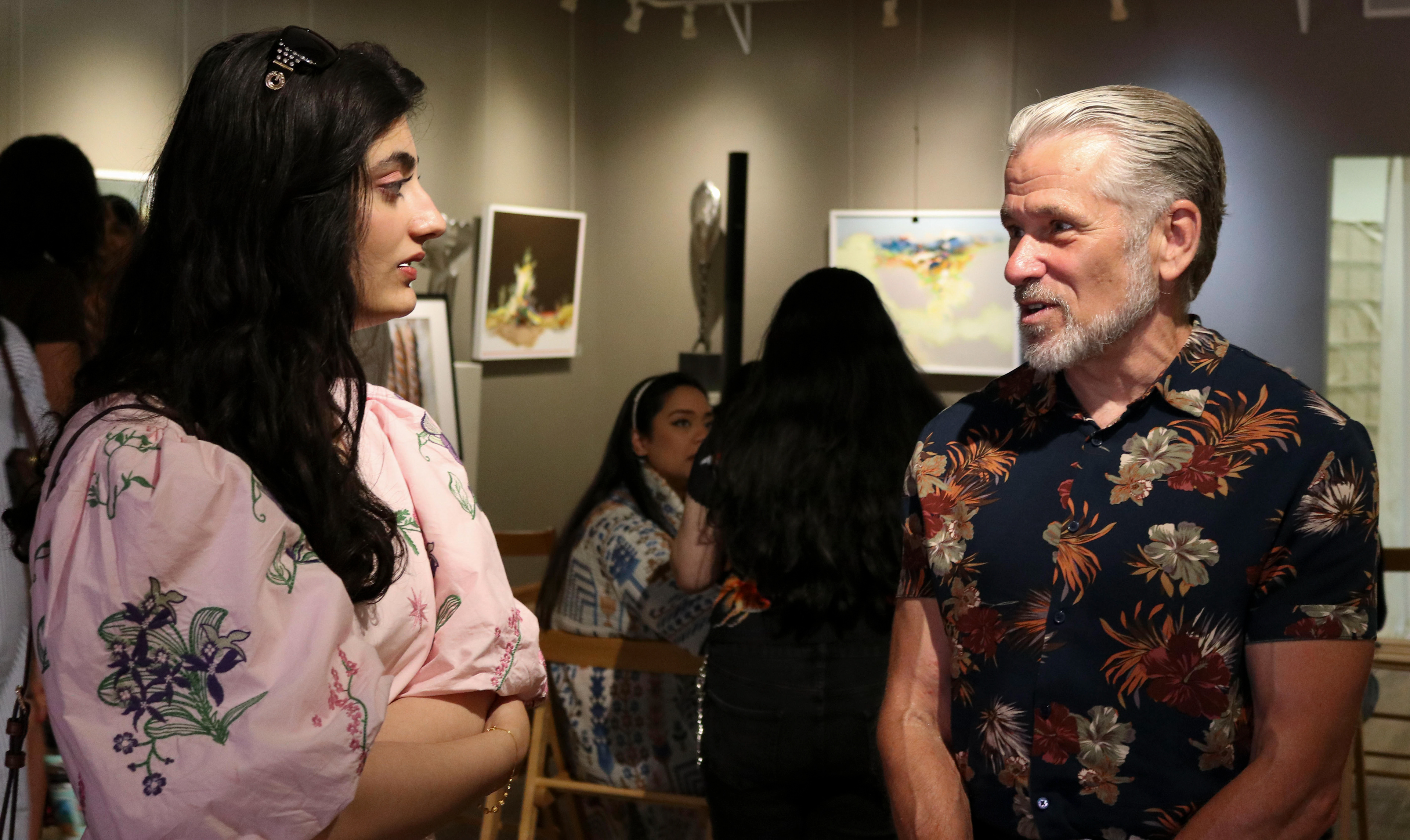 NEW BRUNSWICK, NJ 06/20/2026 CANVAS AND KAHANI: Zainab Masoud speaks with her former high school history teacher about her piece, “Techno-Feudalism.” Central Desi, a South Asian news publication, hosts its first-ever art showcase and open-mic at Alfa Art Gallery on Church Street. Photo by Sunah Choudhry.