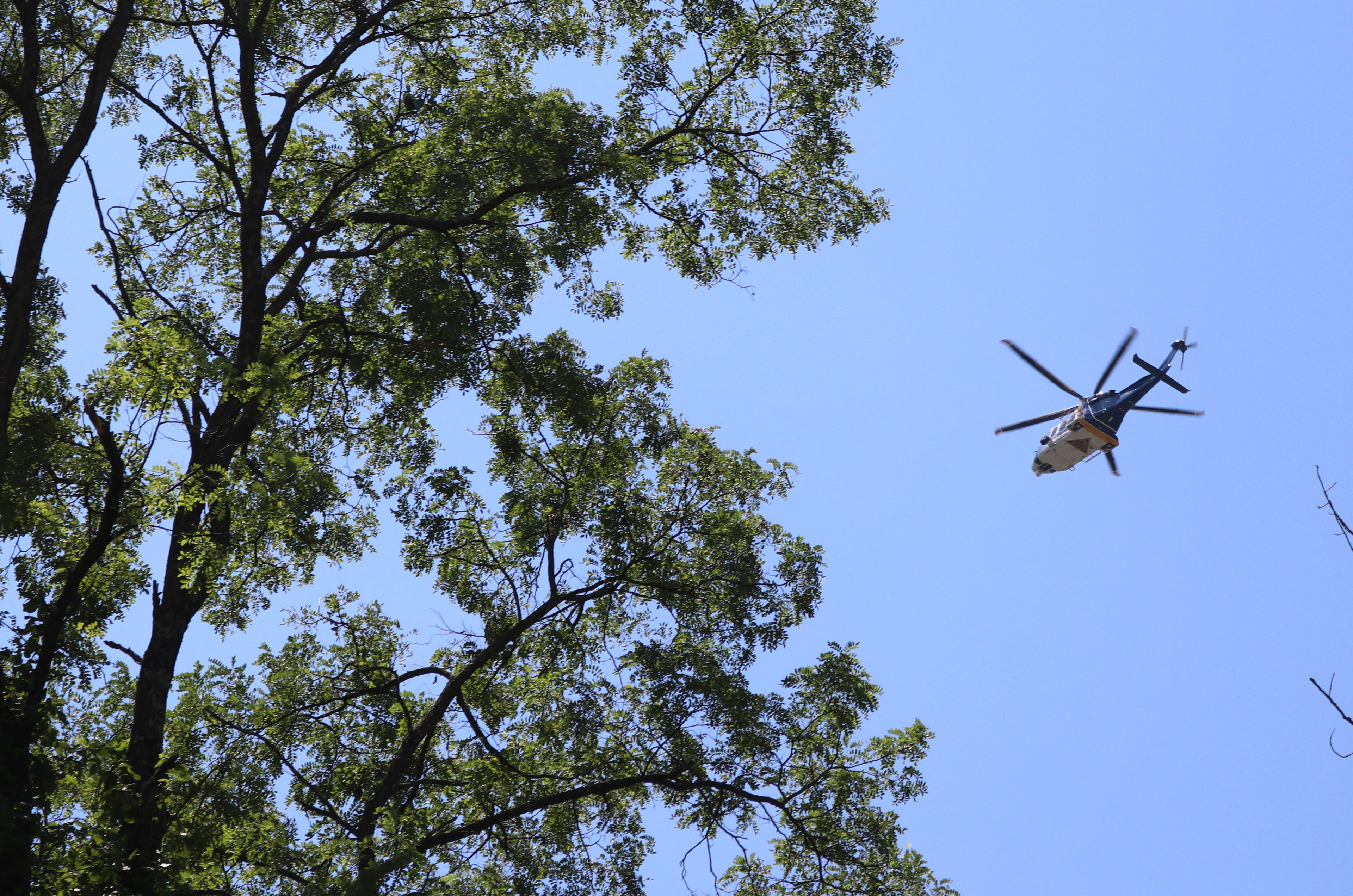 A New Jersey State Police helicopter flies over the Veterans of Foreign Affairs #3401 after a powerful storm in Morris Plains, New Jersey. Photo by Sunah Choudhry.
