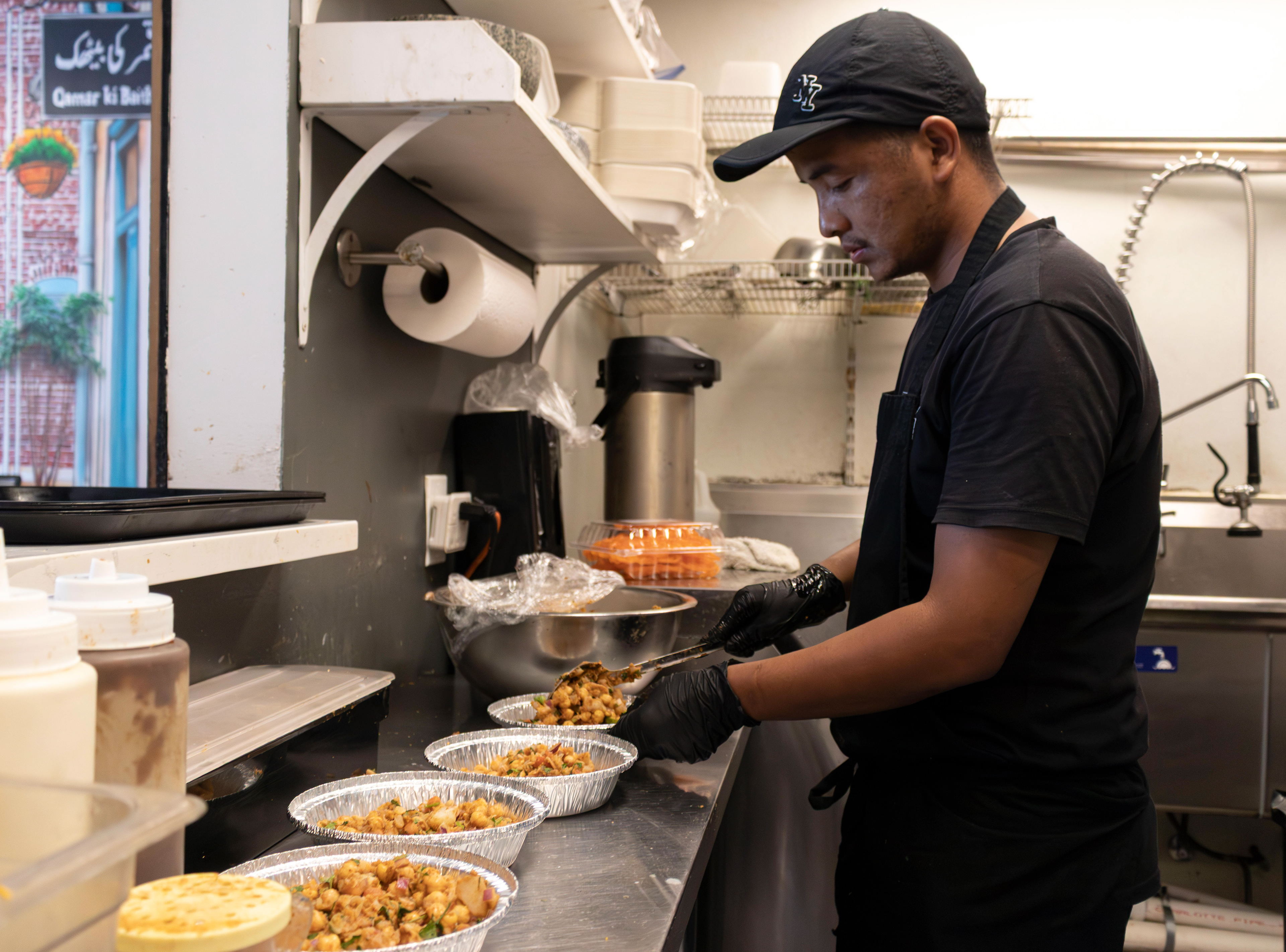 A cook prepares guppa chaat for a to-go order at Food Street in Secaucus. Photo by Sunah Choudhry.