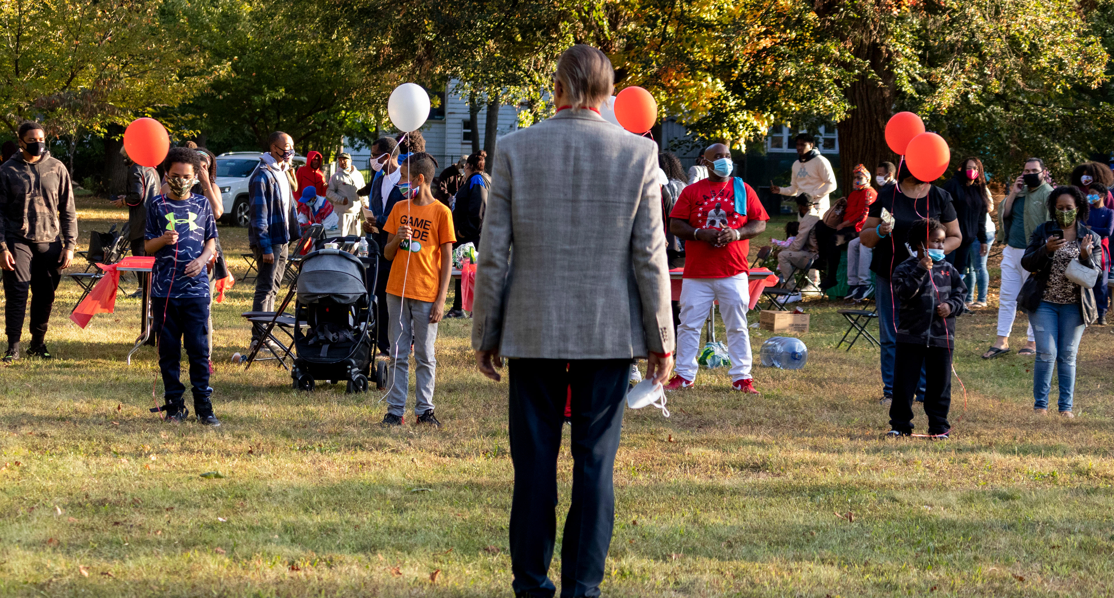 Children line up with Pannell family friend Charles Webster set to release balloons in the air in remembrance of Phillip Pannell on his 47th birthday at Bernard E. Brooks park in Teaneck on Saturday, October 3rd, 2021. (Photo/Sunah Choudhry)
