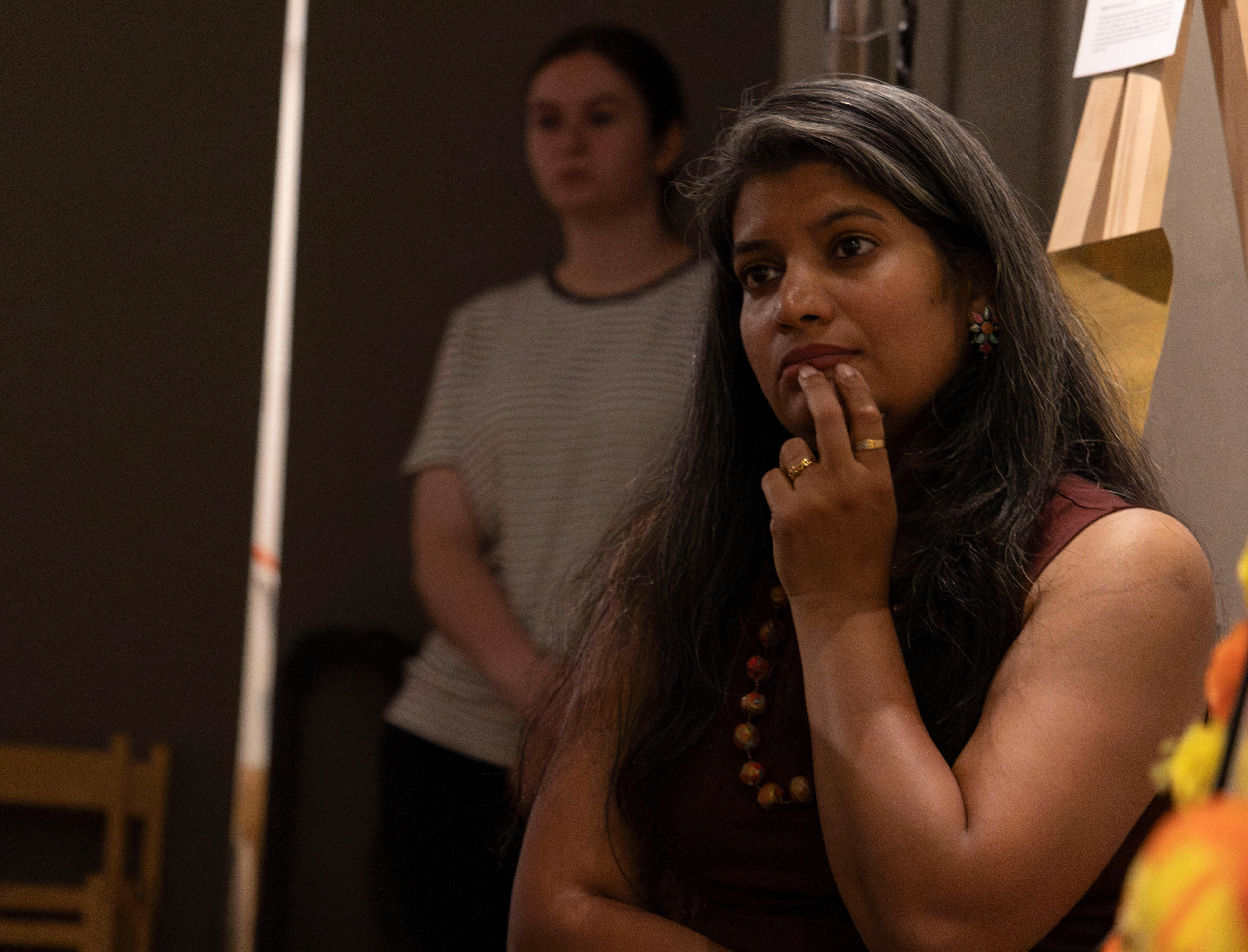 NEW BRUNSWICK, NJ 06/20/2026 CANVAS AND KAHANI: Pyrographist Janhavi Firke’s listens to singer @Rujjygotjams. Central Desi, a South Asian news publication, hosts its first-ever art showcase and open-mic at Alfa Art Gallery on Church Street. Photo by Sunah Choudhry.