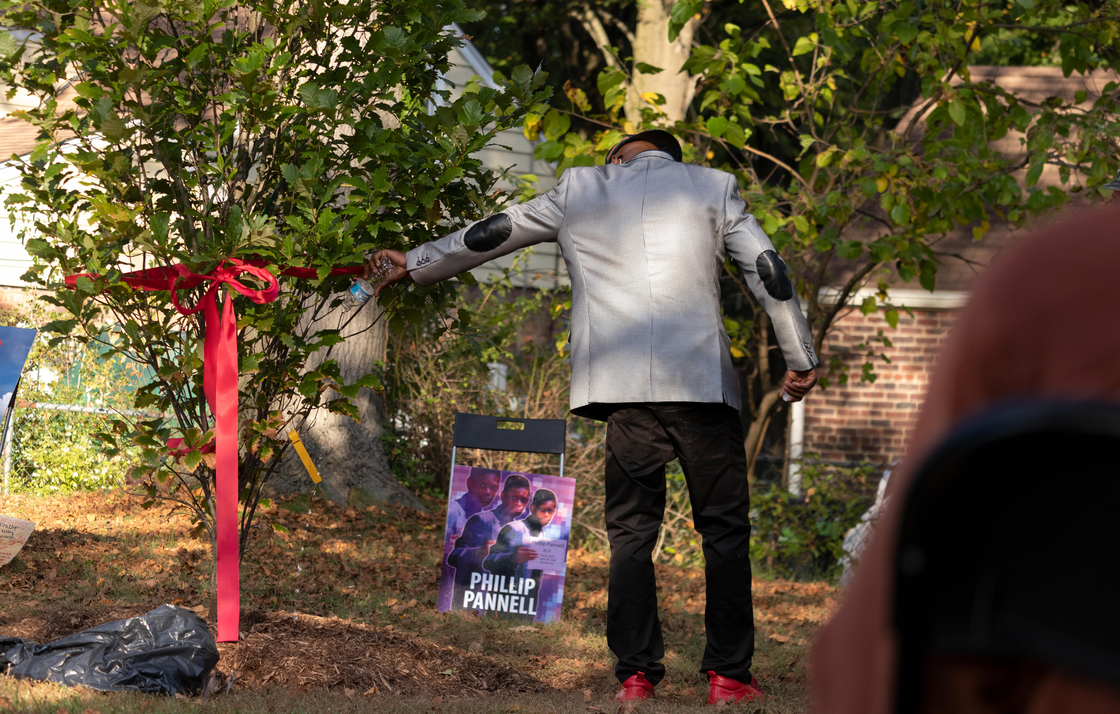 David Harbour pours water on the newly planted tree in remembrance of Phillip Pannell at Bernard E. Brooks park in Teaneck on Saturday, October 3rd, 2021. (Photo/Sunah Choudhry)