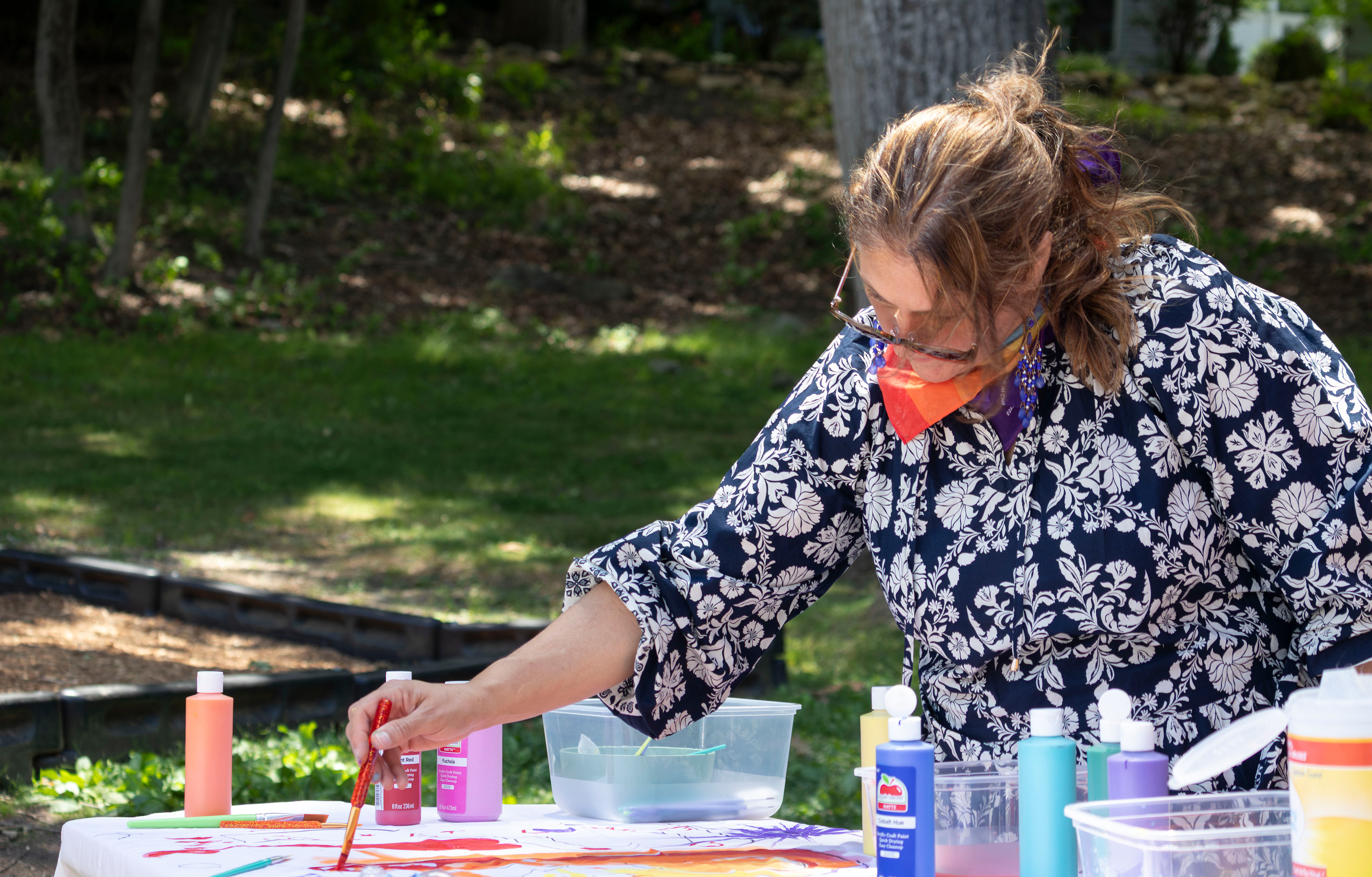BOONTON, NJ 06/20/2026 BOONTON PRIDE AT GRACE LORD PARK: A woman adds to a shared painting with other attendees during Boonton Pride. Boonton residents and attendees gather to celebrate Boonton Pride, listen to speakers, and watch performances by the Mayo Performing Arts Company. 