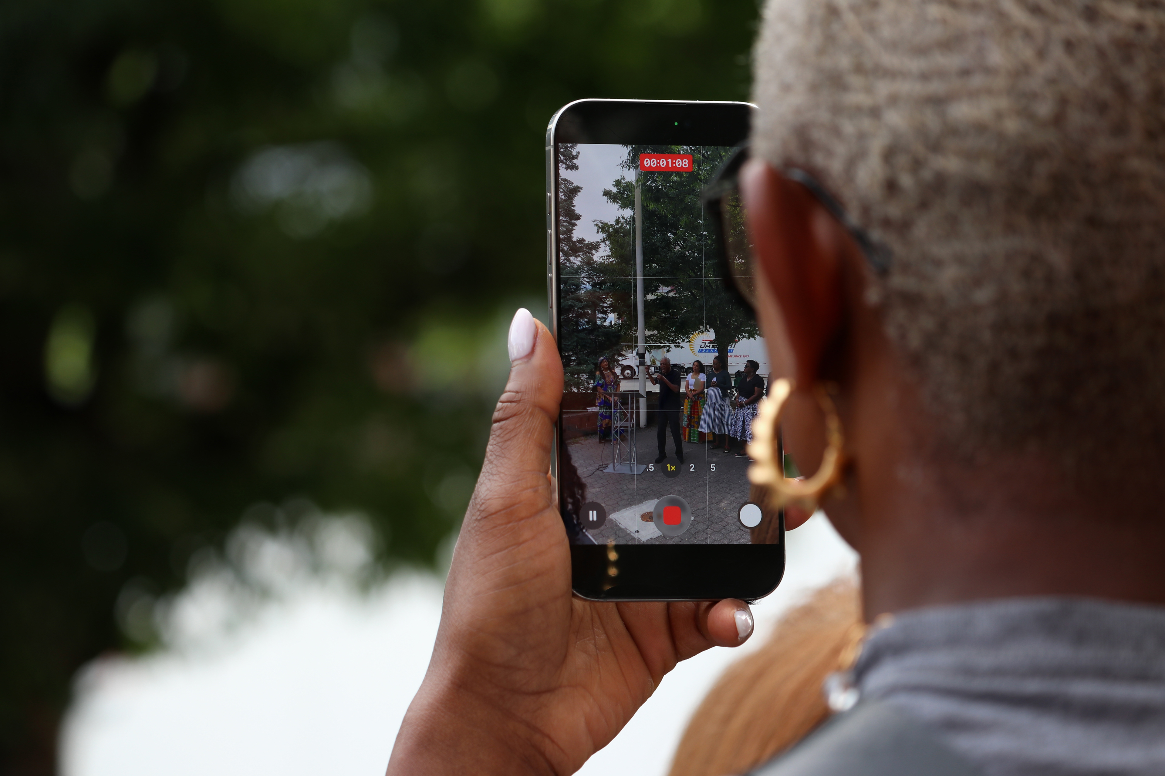 MONTCLAIR, NJ 06/19/2026 JUNETEENTH FLAG RAISING: A woman records the Founder of the People’s Organization for Progress, Larry Hamm, on her phone. Photo by Sunah Choudhry.
