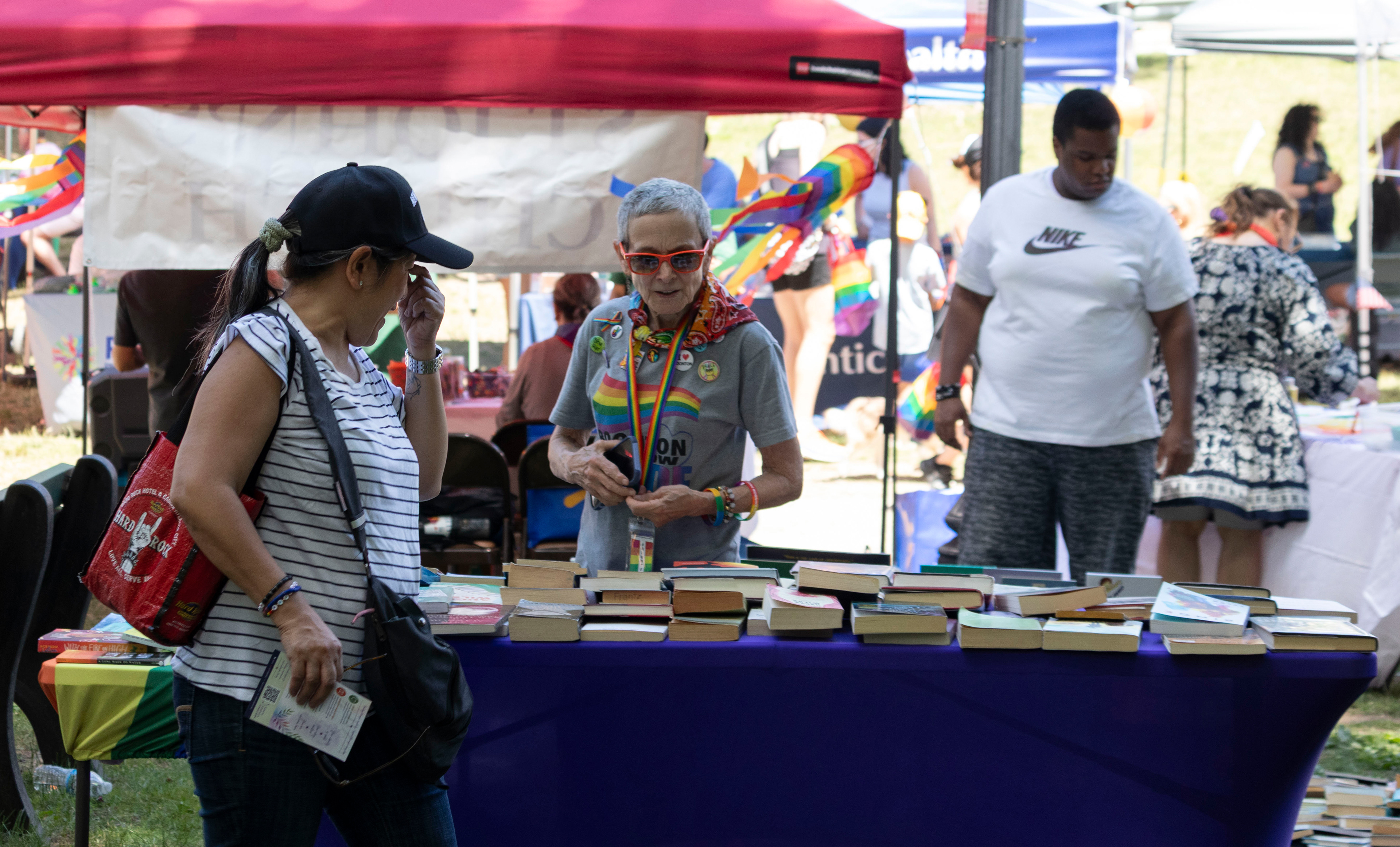 BOONTON, NJ 06/20/2026 BOONTON PRIDE AT GRACE LORD PARK: A woman browses the Banned Books table, where free books are available to attendees. Boonton residents and visitors gather to celebrate Pride, hear from speakers and watch performances by the Mayo Performing Arts Company.