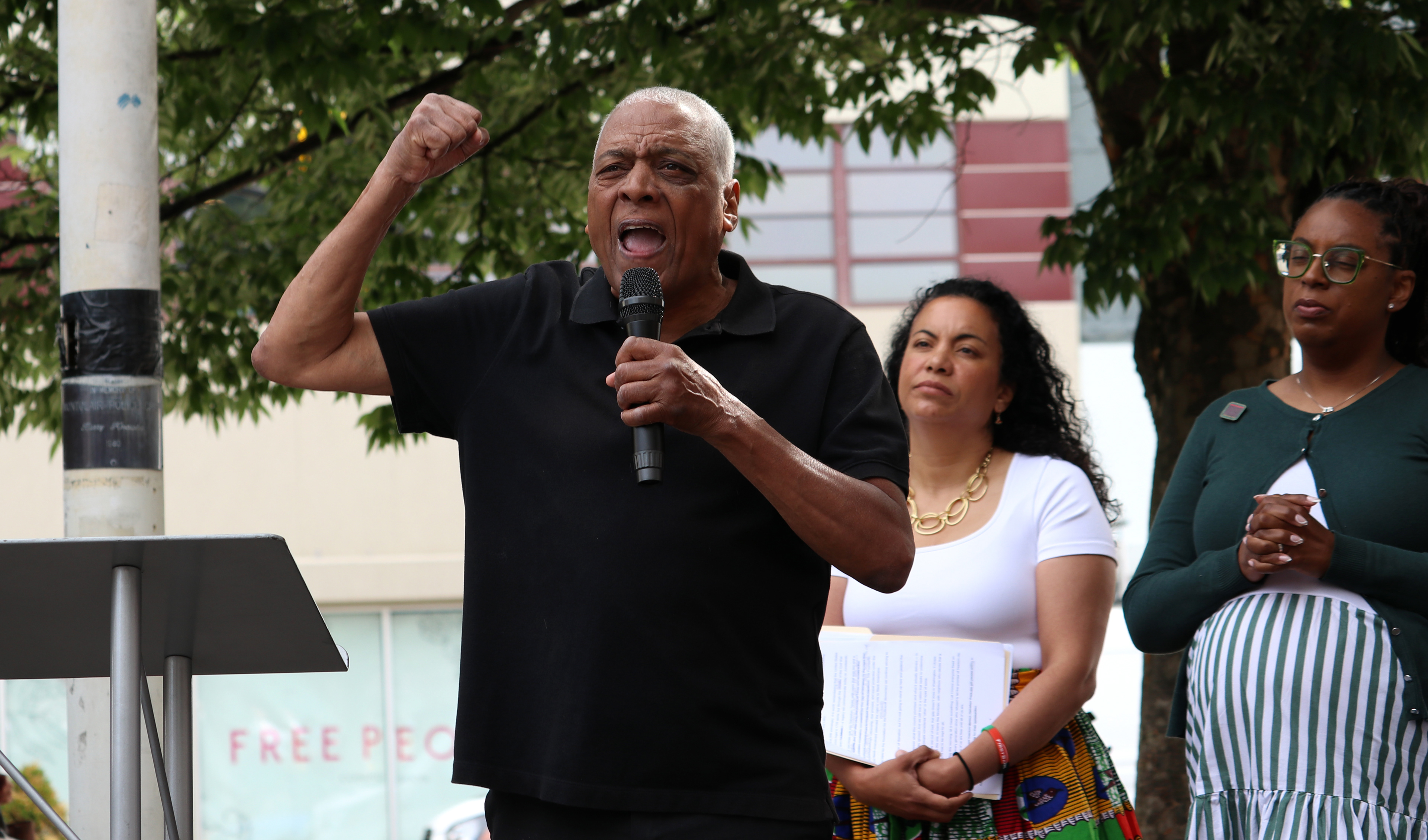 MONTCLAIR, NJ 06/19/2026 JUNETEENTH FLAG RAISING: Founder of the People’s Organization for Progress, Larry Hamm, speaks about the Emancipation Proclamation of 1875. New Jersey District 11 Congresswoman Analilia Mejias stands behind him. Montclair residents gathered to honor and celebrate Juneteenth, listen to local politicians and leaders, and watch a performance by the students from Beyond the Boogie Dance Company. Photo by Sunah Choudhry.