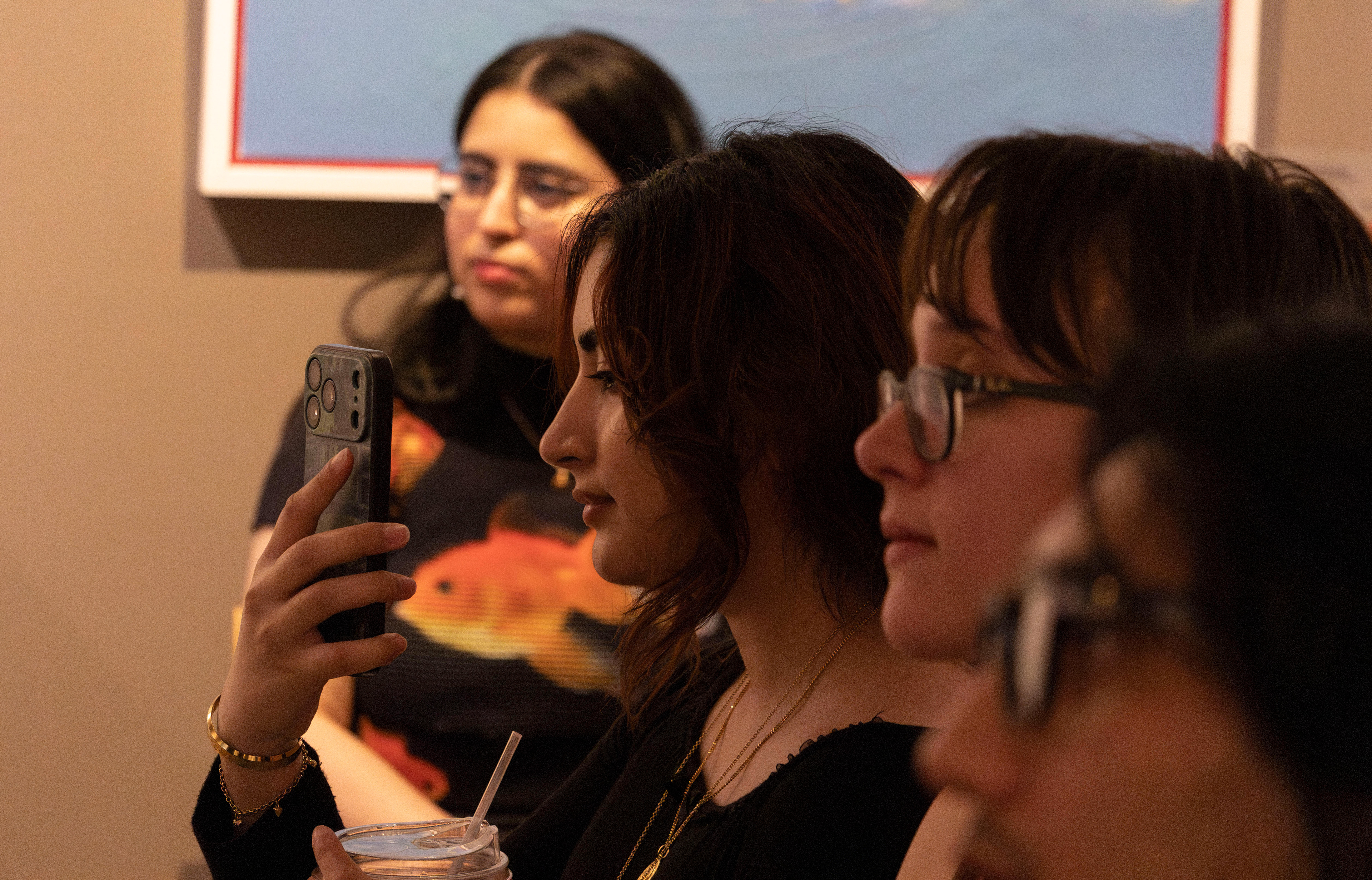 NEW BRUNSWICK, NJ 06/20/2026 CANVAS AND KAHANI: An attendee records singer @Rukkygotjams performing a song at Canvas and Kahani. Central Desi, a South Asian news publication, hosts its first-ever art showcase and open-mic at Alfa Art Gallery on Church Street. Photo by Sunah Choudhry.