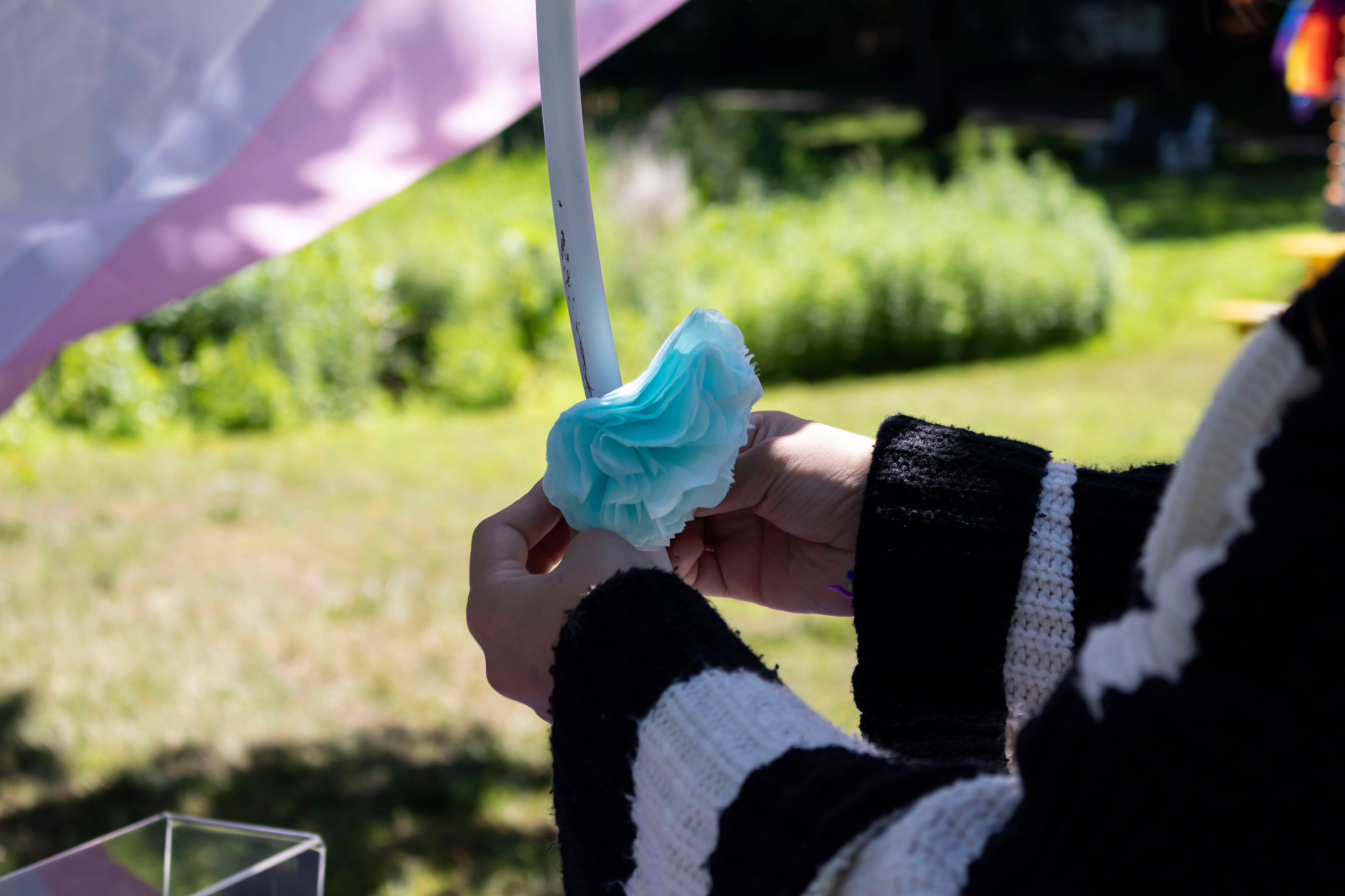 BOONTON, NJ 06/20/2026 BOONTON PRIDE AT GRACE LORD PARK: An attendee makes a tissue-paper flower to add to a memorial at performer and artist Vincent Jude’s table honoring transgender people who have died since last year’s Boonton Pride. Boonton residents and visitors gather to celebrate Pride, hear speakers and watch performances by the Mayo Performing Arts Company.