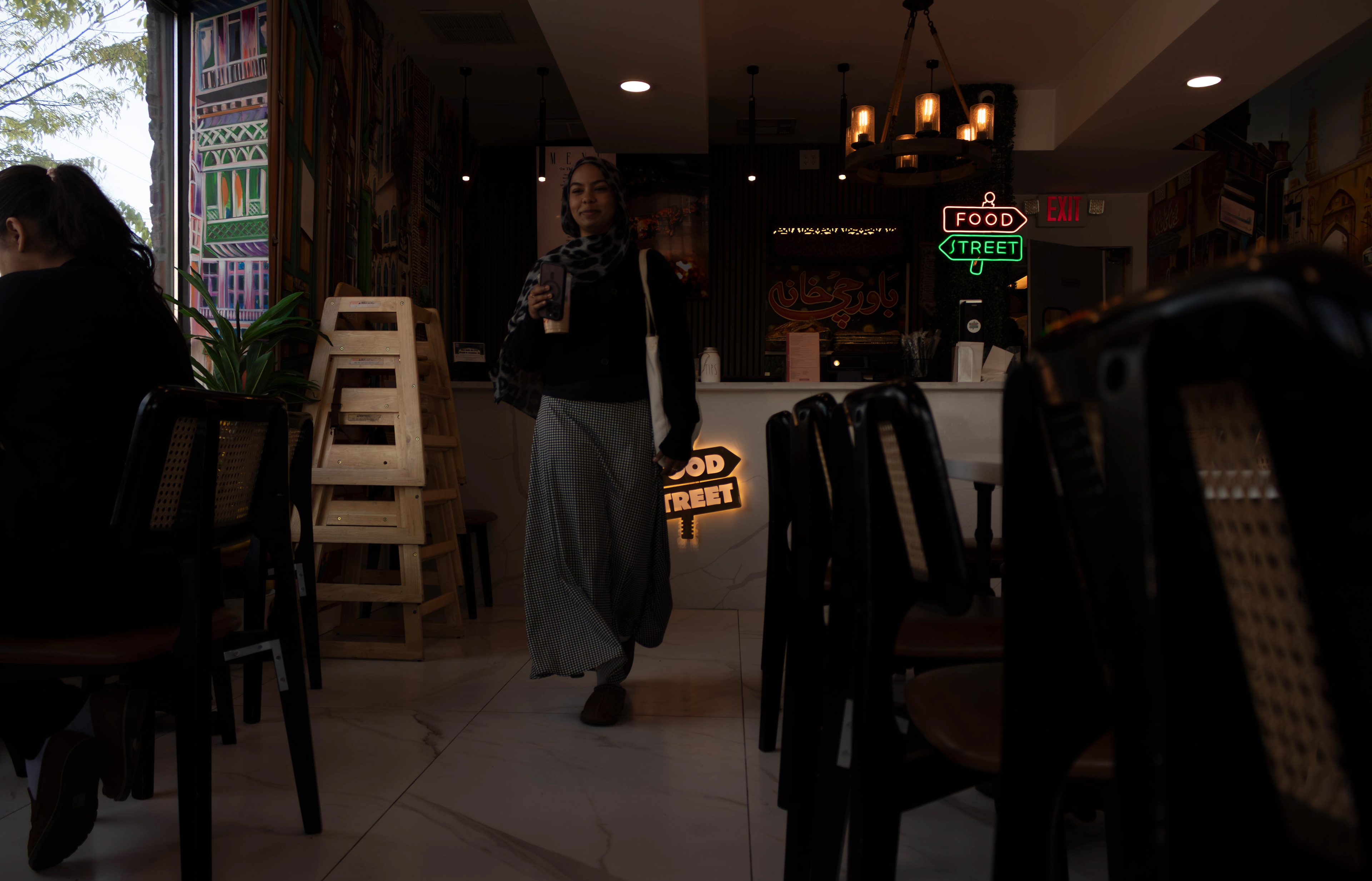 Fatima Eldei, 20, walks out Food Street after dining with a friend. Photo by Sunah Choudhry.