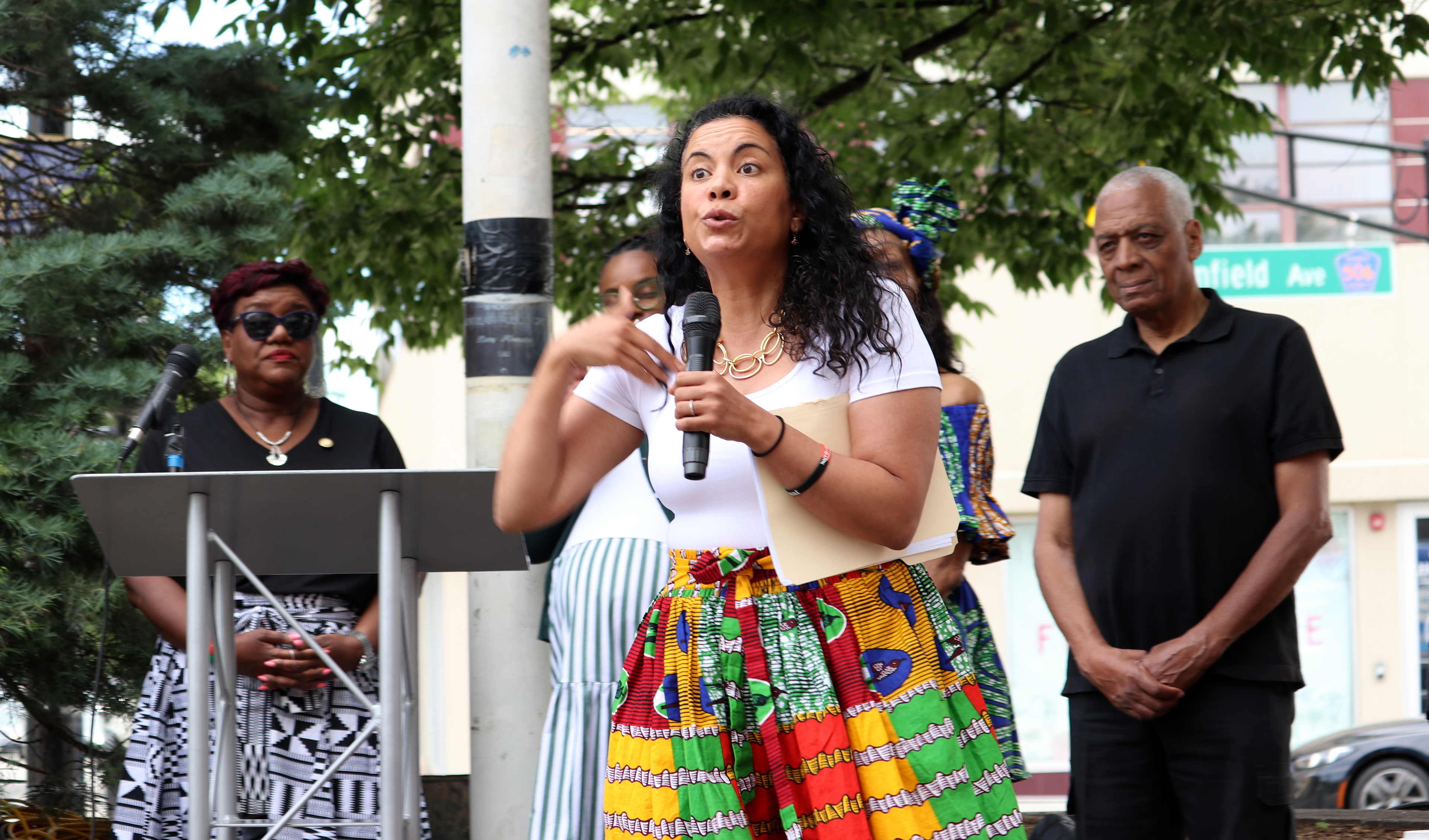 MONTCLAIR, NJ 06/19/2026 JUNETEENTH FLAG RAISING: United States Representitive (NJ-11) Analilia Mejia speaks to the crowd while United States House Represenative (NJ-10) Lamonica Mciver, Montclair’s 4th Ward Councilwoman Aminah Tohler, and Founder of the People’s Organization for Progress Larry Hamm stand side-by-side. Photo by Sunah Choudhry.