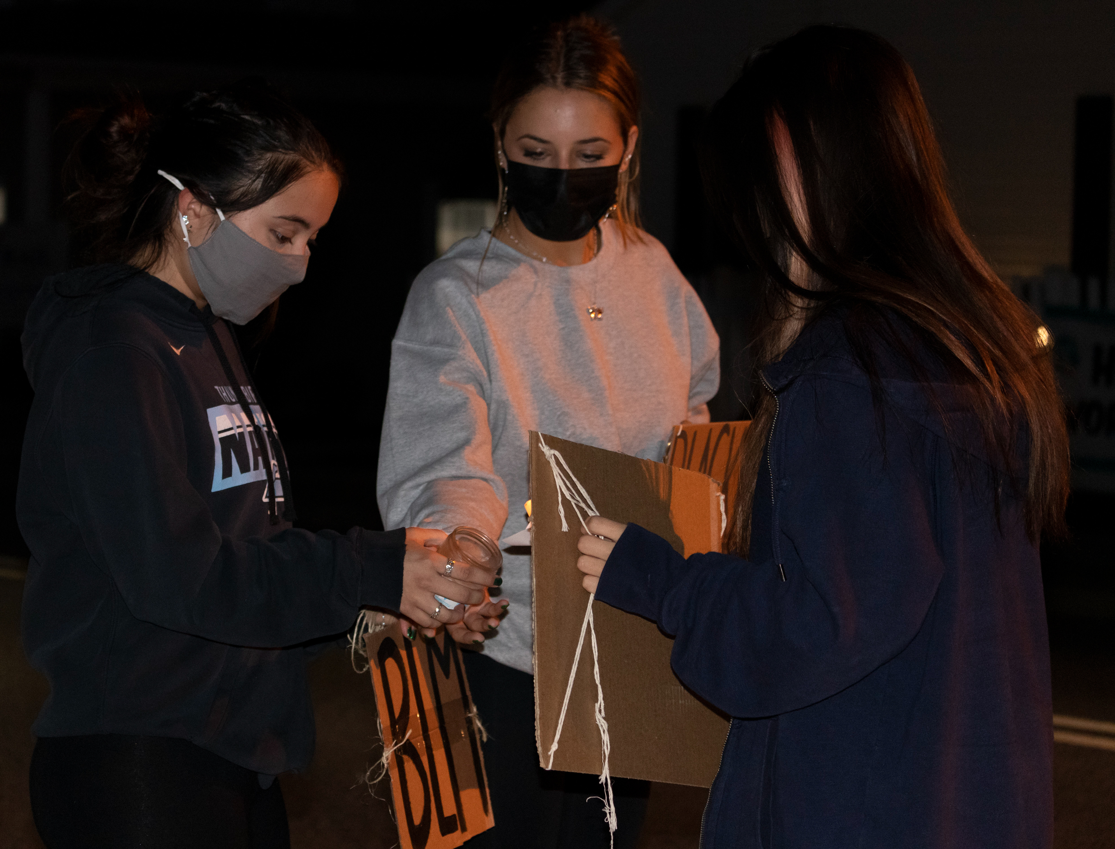 Students from Ramsey High School gather together to light a candle in support for the Ramsey phone call in outside of Ramsey town hall. (Photo/Sunah Choudhry)