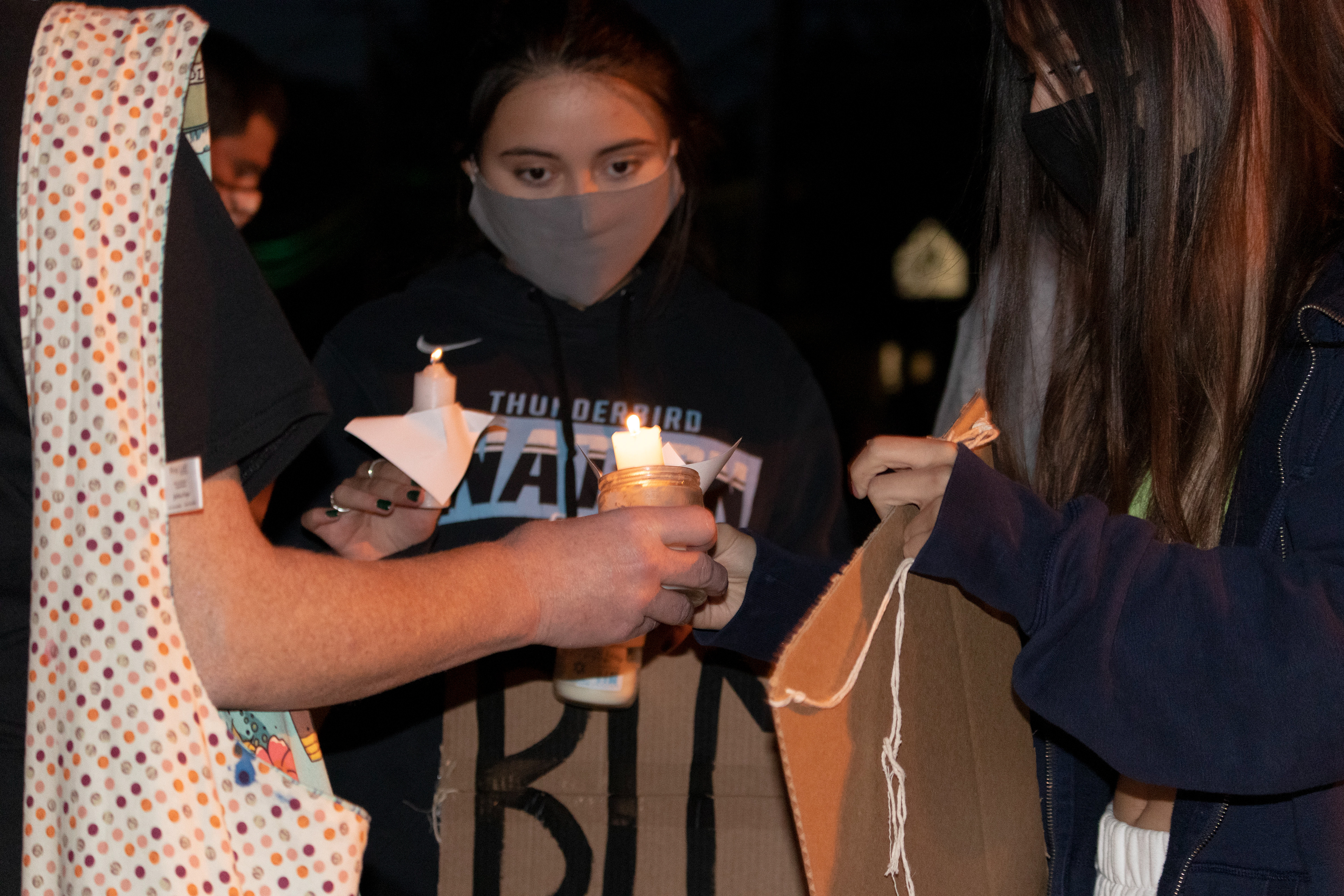Students from Ramsey High School gather together to light a candle in support for the Ramsey phone call in outside of Ramsey town hall. (Photo/Sunah Choudhry)