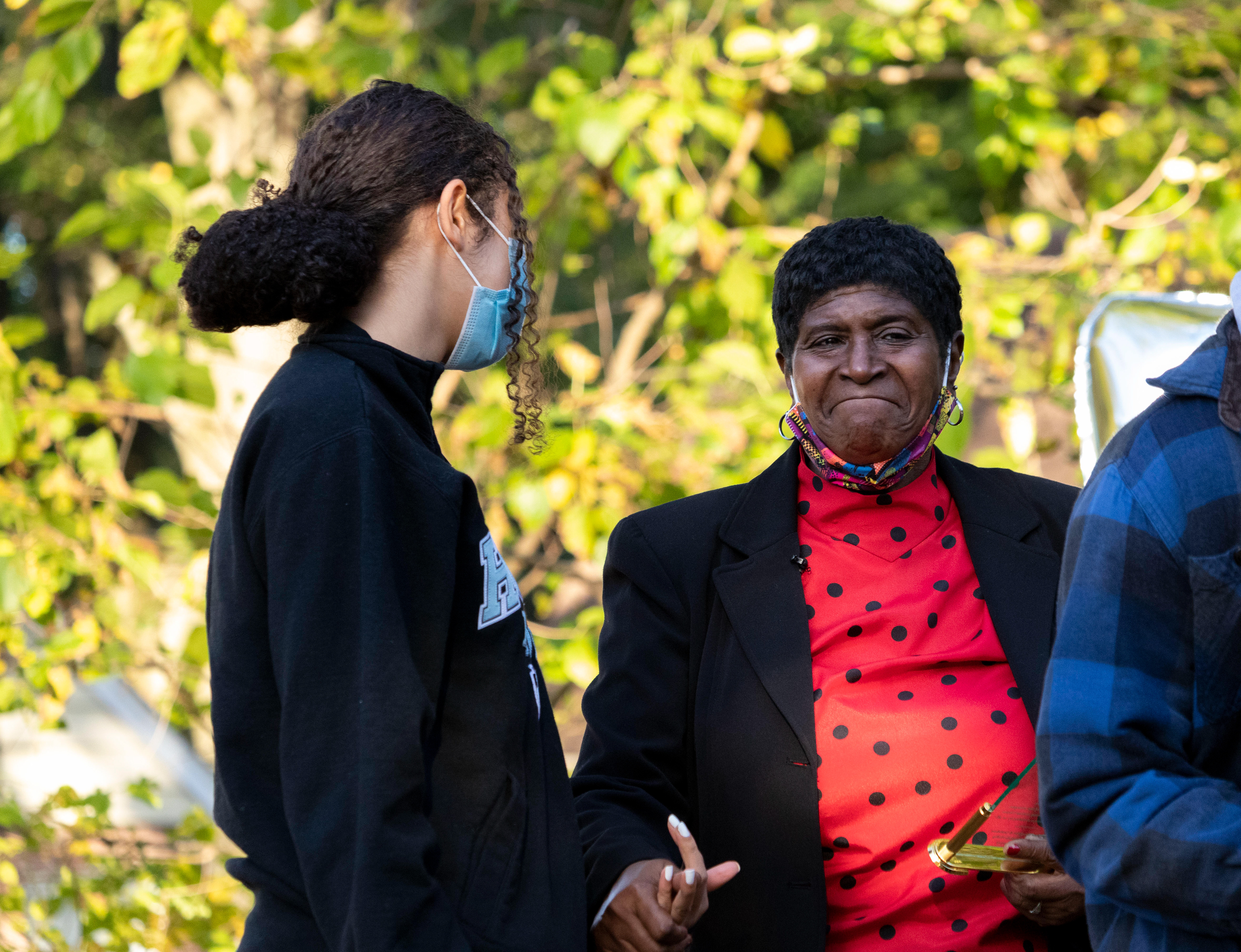 Thelma Danzer holds onto @BLMTeaneck Instagram organizer Michaela Glavin’s hand before passing over the microphone to her in remembrance of Phillip Pannell on his 47th birthday at Bernard E. Brooks park in Teaneck on Saturday, October 3rd, 2021. (Photo/Sunah Choudhry)