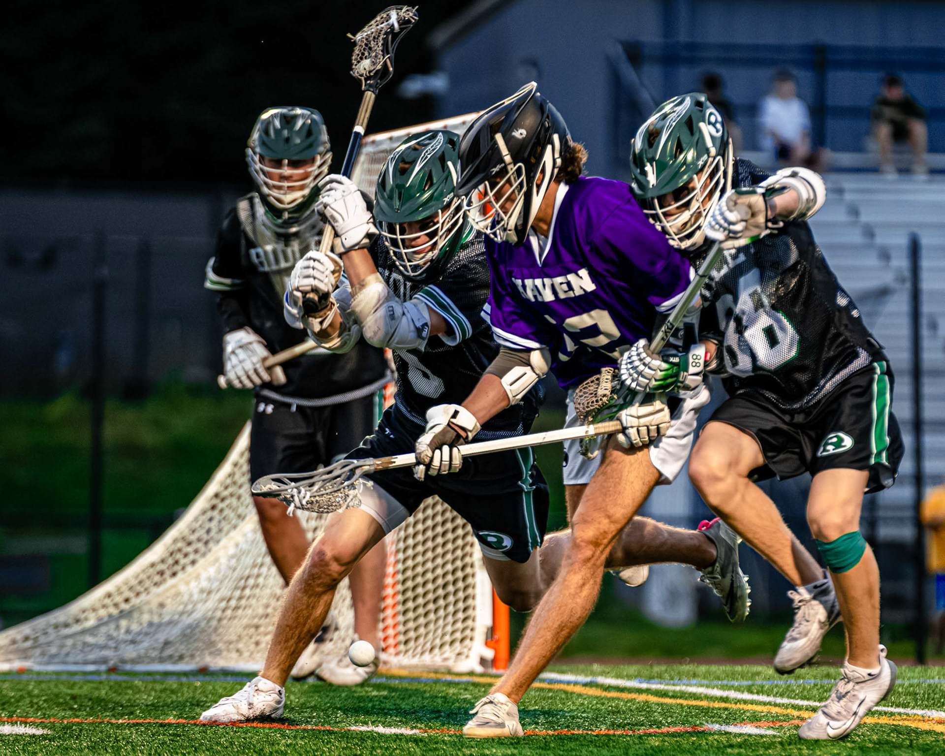 Among a crowd of Green Raiders, senior midfielder Henry Strauss hunts down a loose ball.