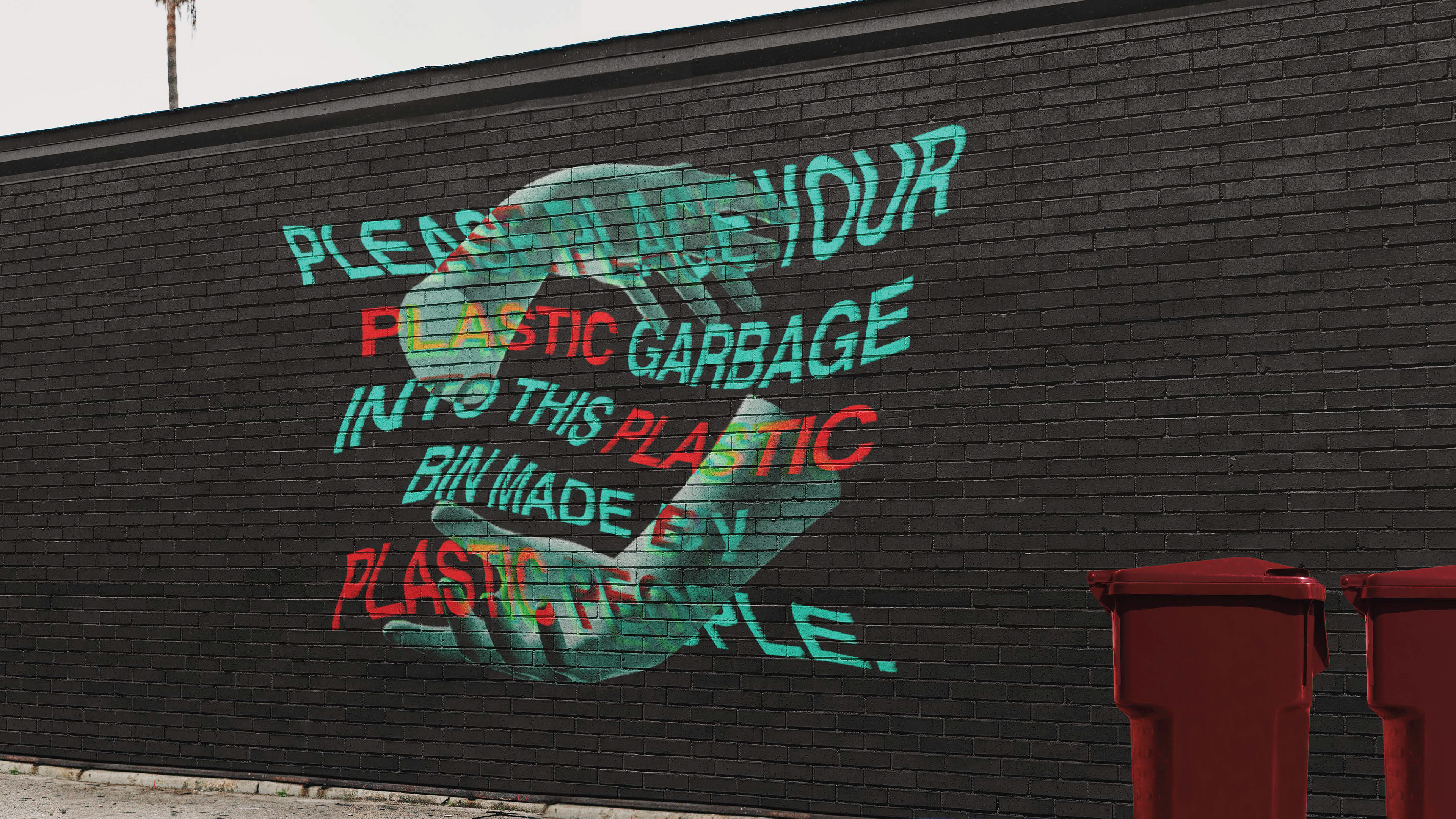 A mural next to recycling bins encourage the public to recycle.