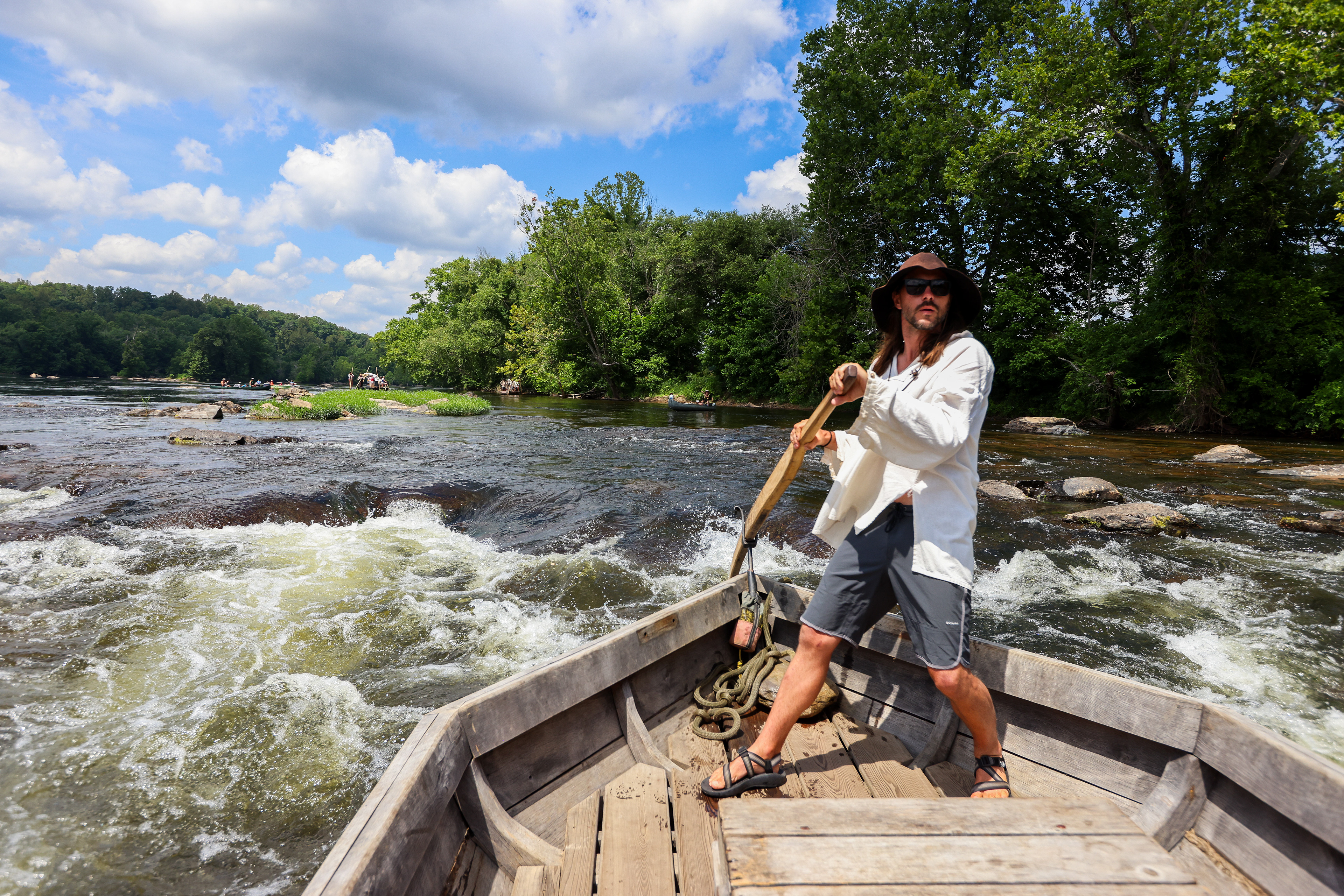 Will Smith pilots the batteau Morning Dew through strong rapids on Wednesday, June 19, 2024, during the James River Batteau Festival's voyage to Scottsville. While Smith, an experienced batteauman, piloted the Dew through the rapids with no problems, past years have seen boats severely damaged if they collide with rocks.