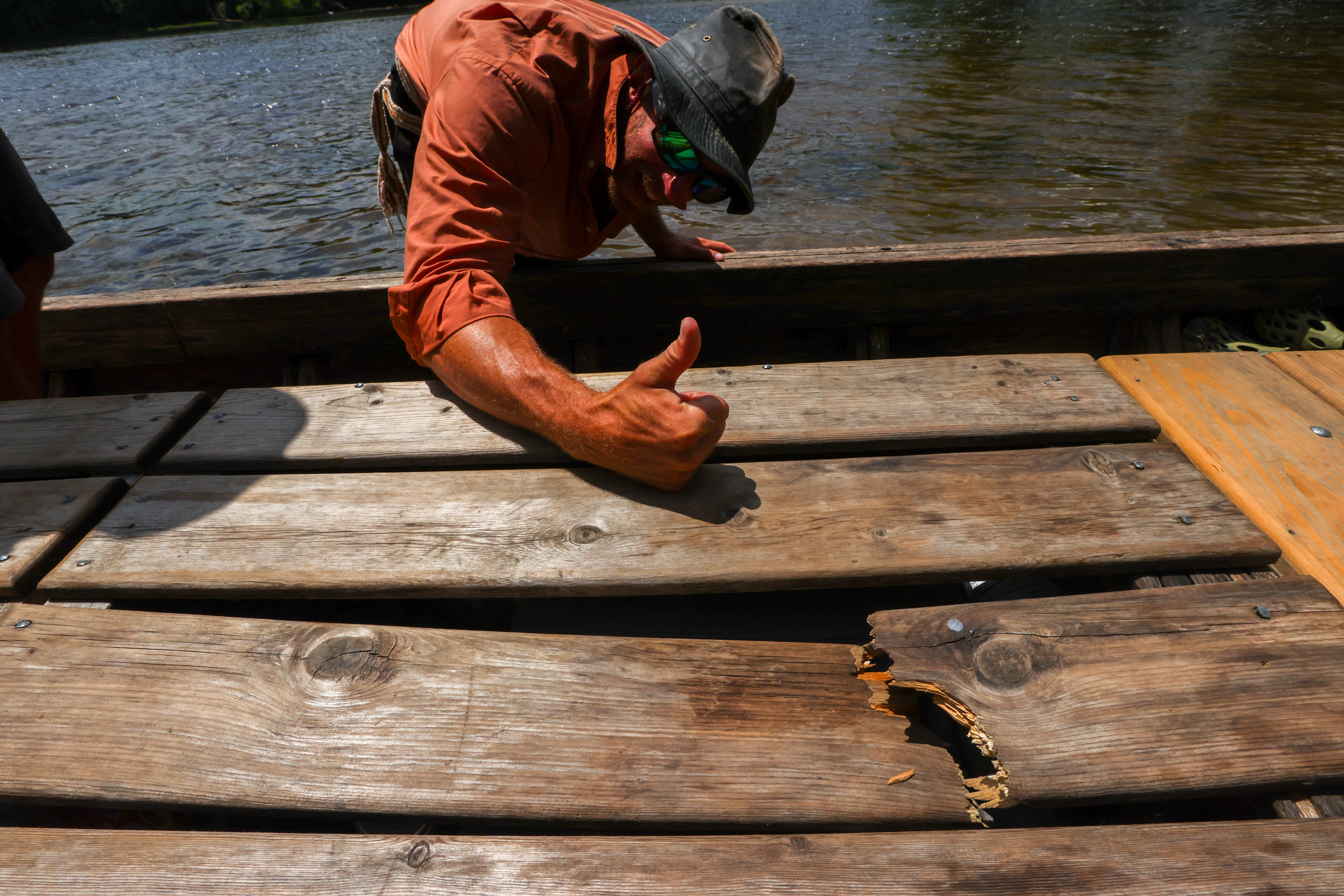 Josh Hinkle shows off a plank on the top of his batteau that was damaged in the rapids on Wednesday, June 19, 2024, during the James River Batteau Festival's voyage to Scottsville. 