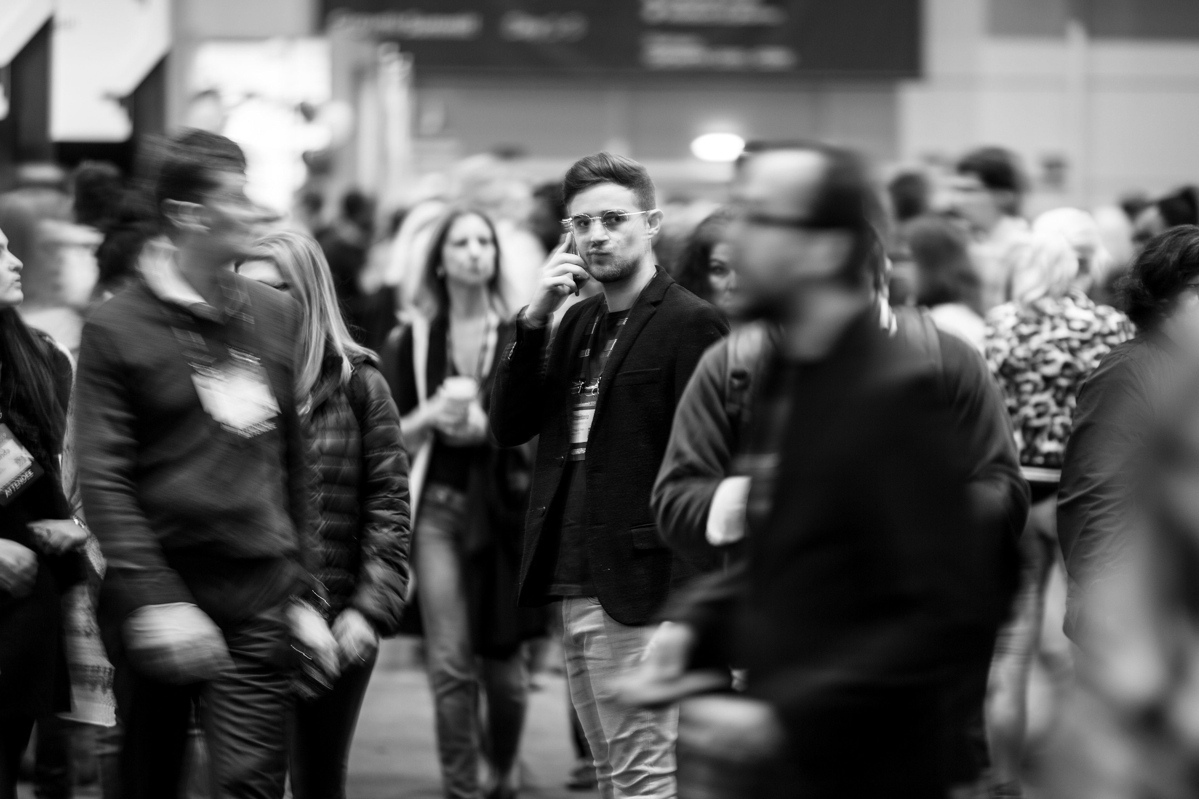 A man speaks on the phone amidst the crowd