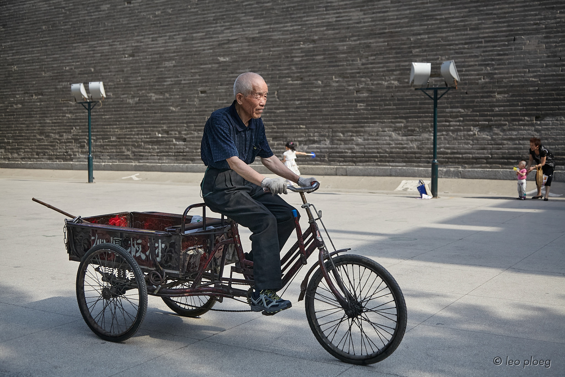 A man rides his tricycle cart through Xian