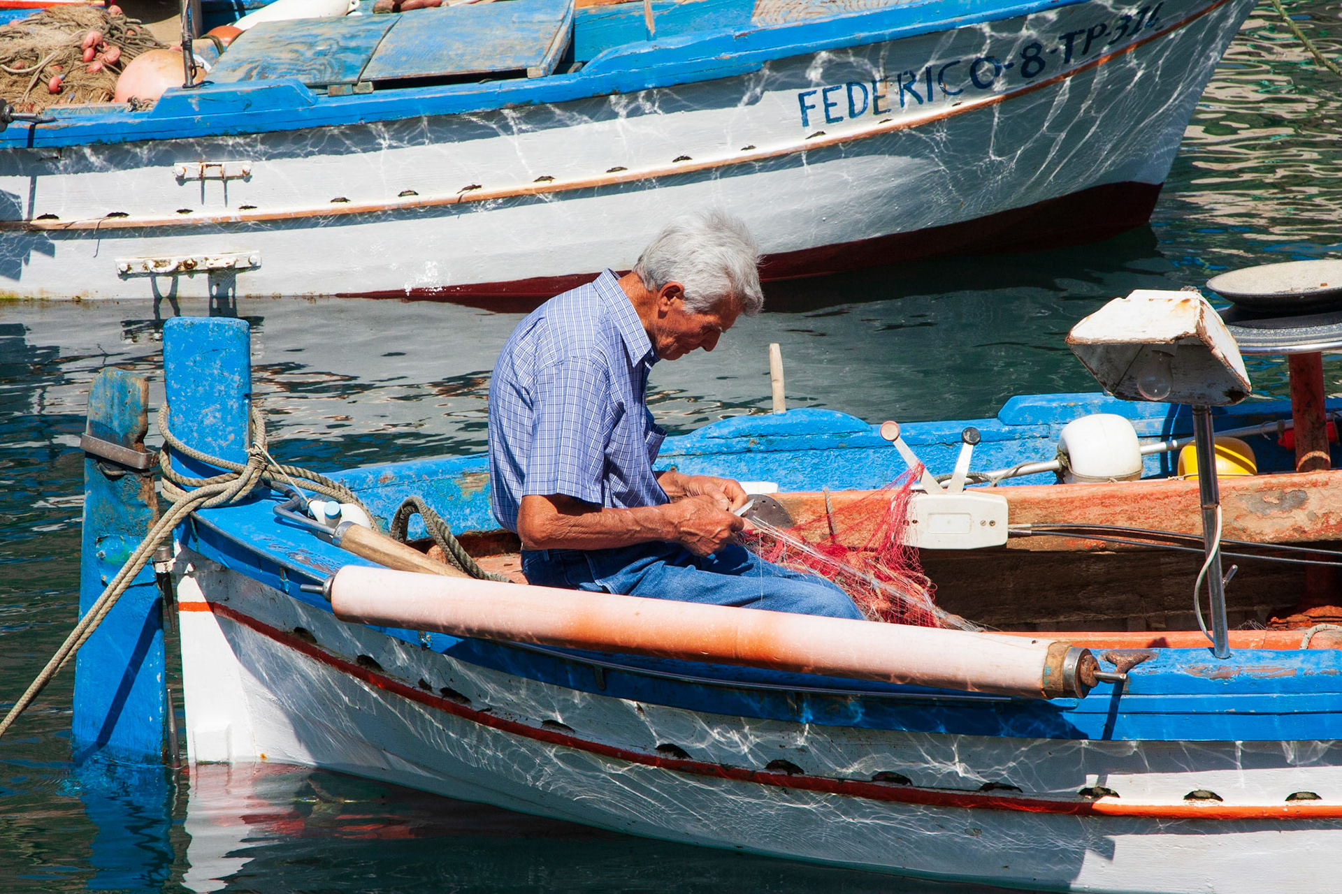 Fisherman repairing his fishing gear