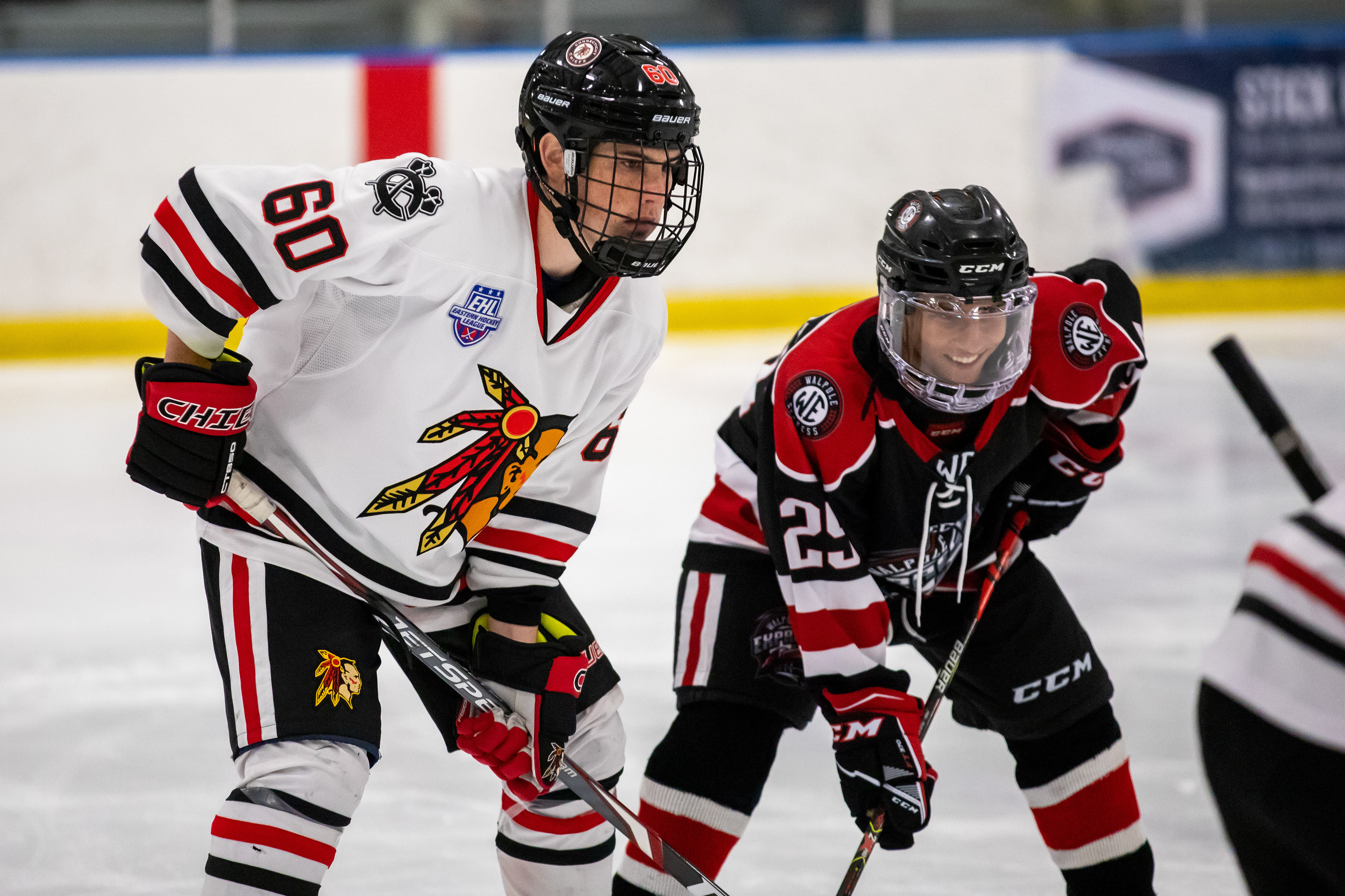 Colin Hines (left) and a Walpole forward wait in anticipation for the puck to drop.
