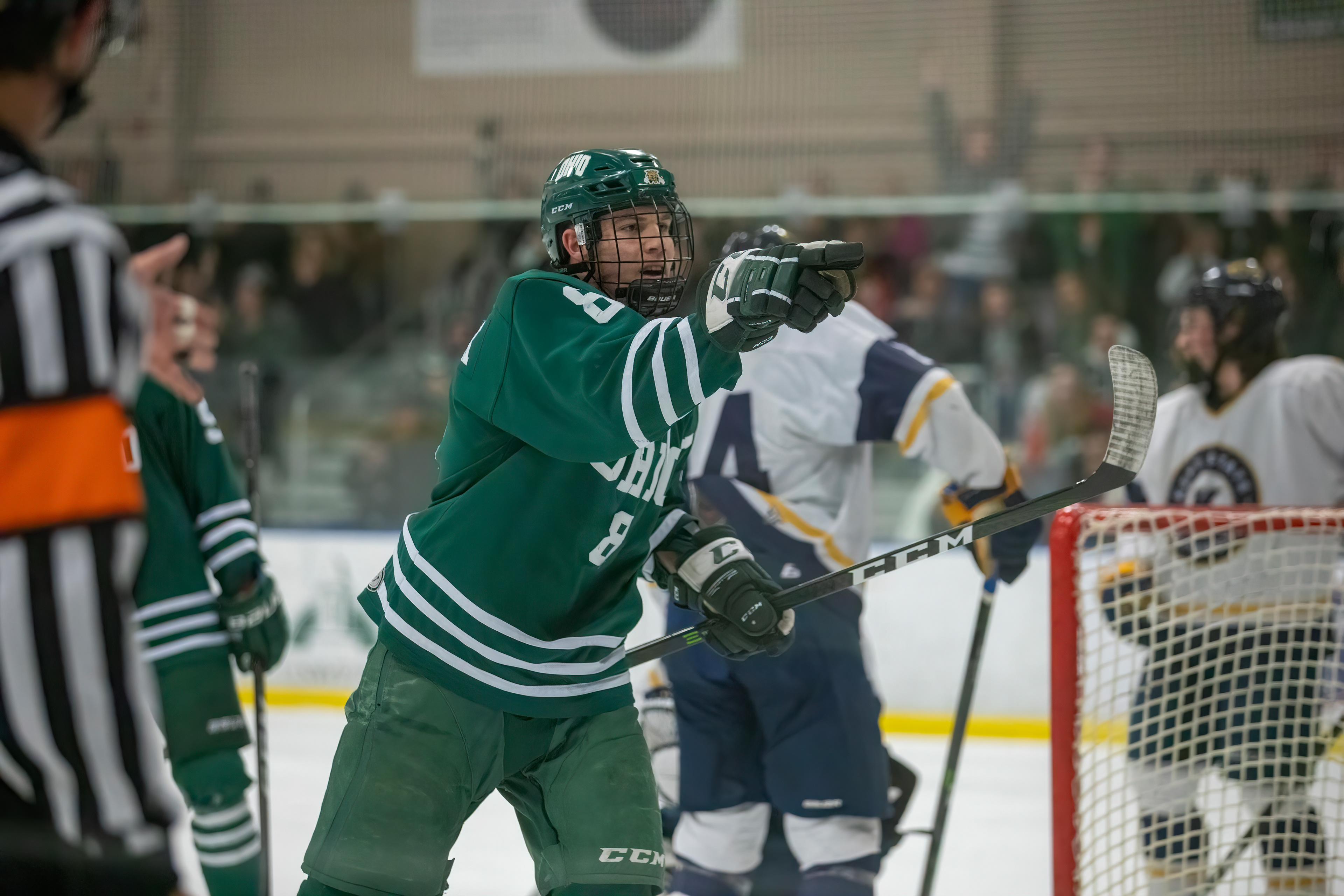 Kyle Craddick points to a teammate following a Bobcat goal, as a fan celebrates in the crowd.