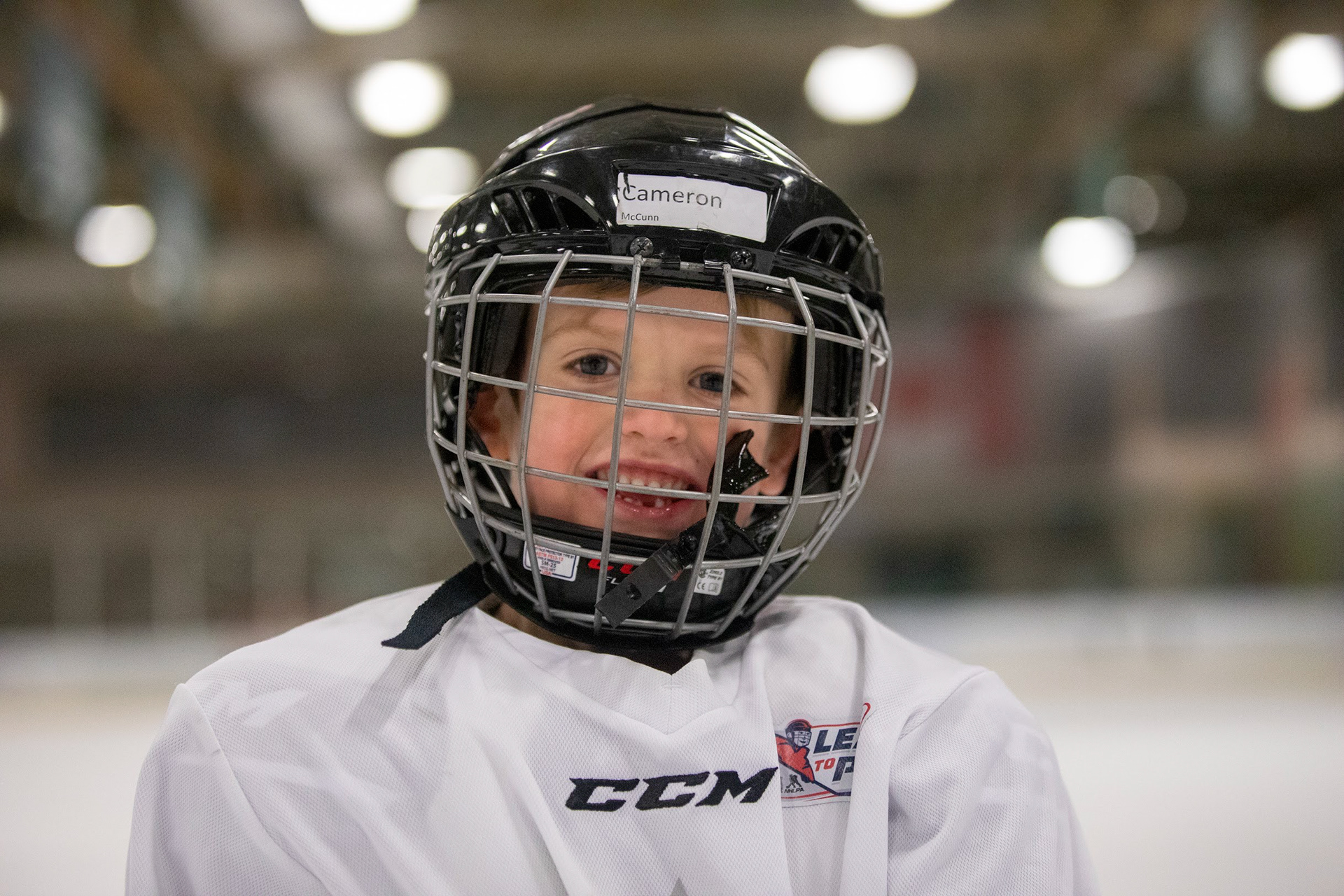 Cameron, a young hockey player, smiles for the camera.