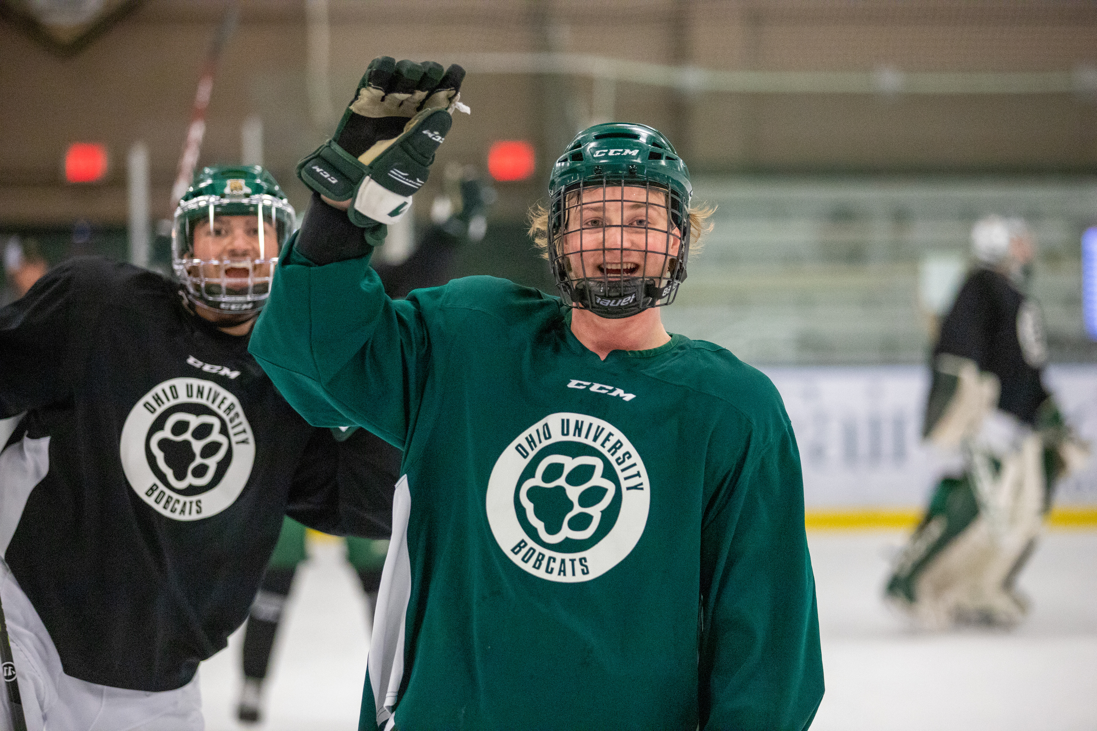 Shawn Baird (center) poses for the camera during practice as Zach Frank (back) photobombs him.