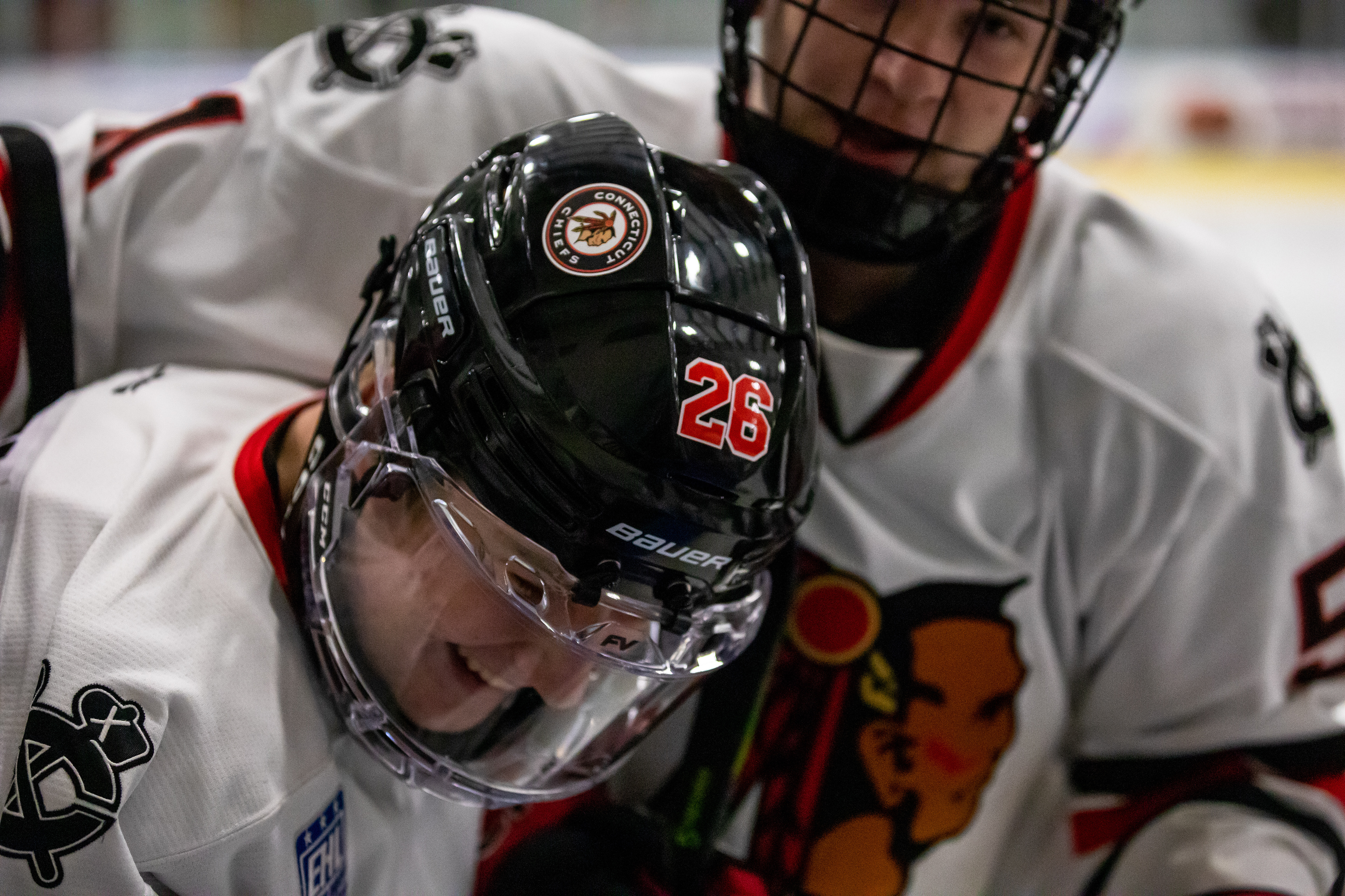 Evan Fassett (#26) is hugged by Owen Johnson (back) following a goal.