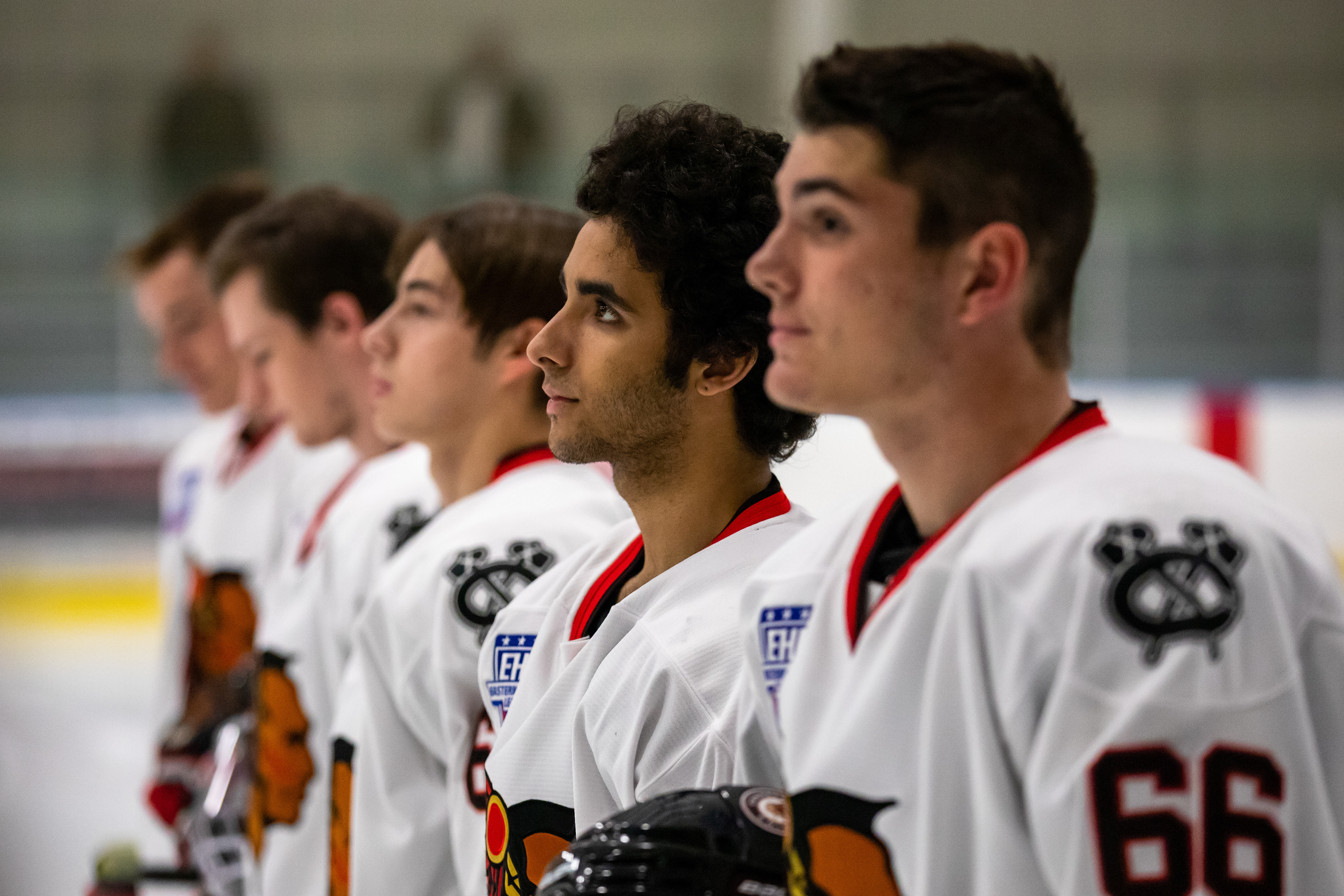 Marcus Boigris (second from right) looks at the flag with his teammates during the National Anthem.